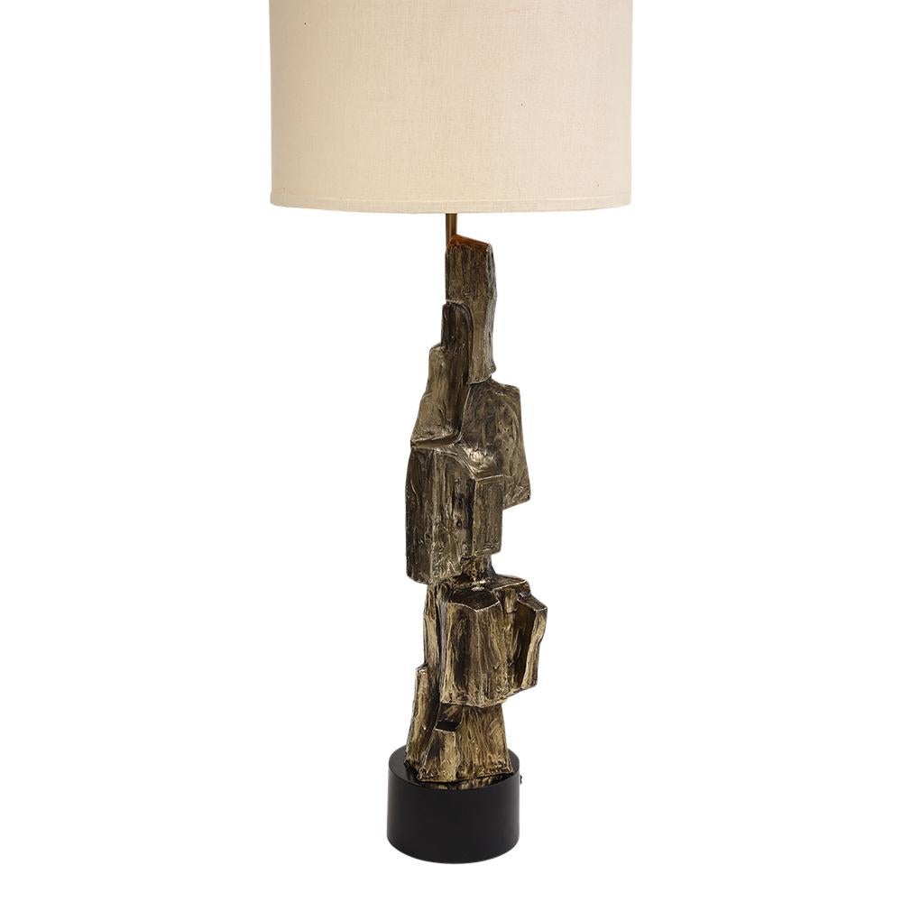 Tall Laurel Table Lamp, Brutalist, Cubist, Brass, Bronze. Sculptural table lamp composed of three piece fitted cast metal and plated in a dark brass [bronze] finish and mounted to a circular black metal base. Minor unevenness to the bronze plating