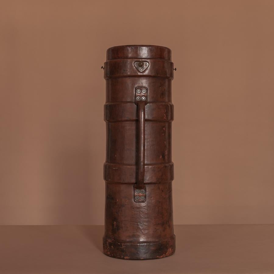 A superb leather cordite carrier which would make a perfect umbrella or polo stick stand. Constructed from a core of cork, bound in leather and lined in canvas. This munitions container dates circa 1915. A galvanised metal liner has been fitted to