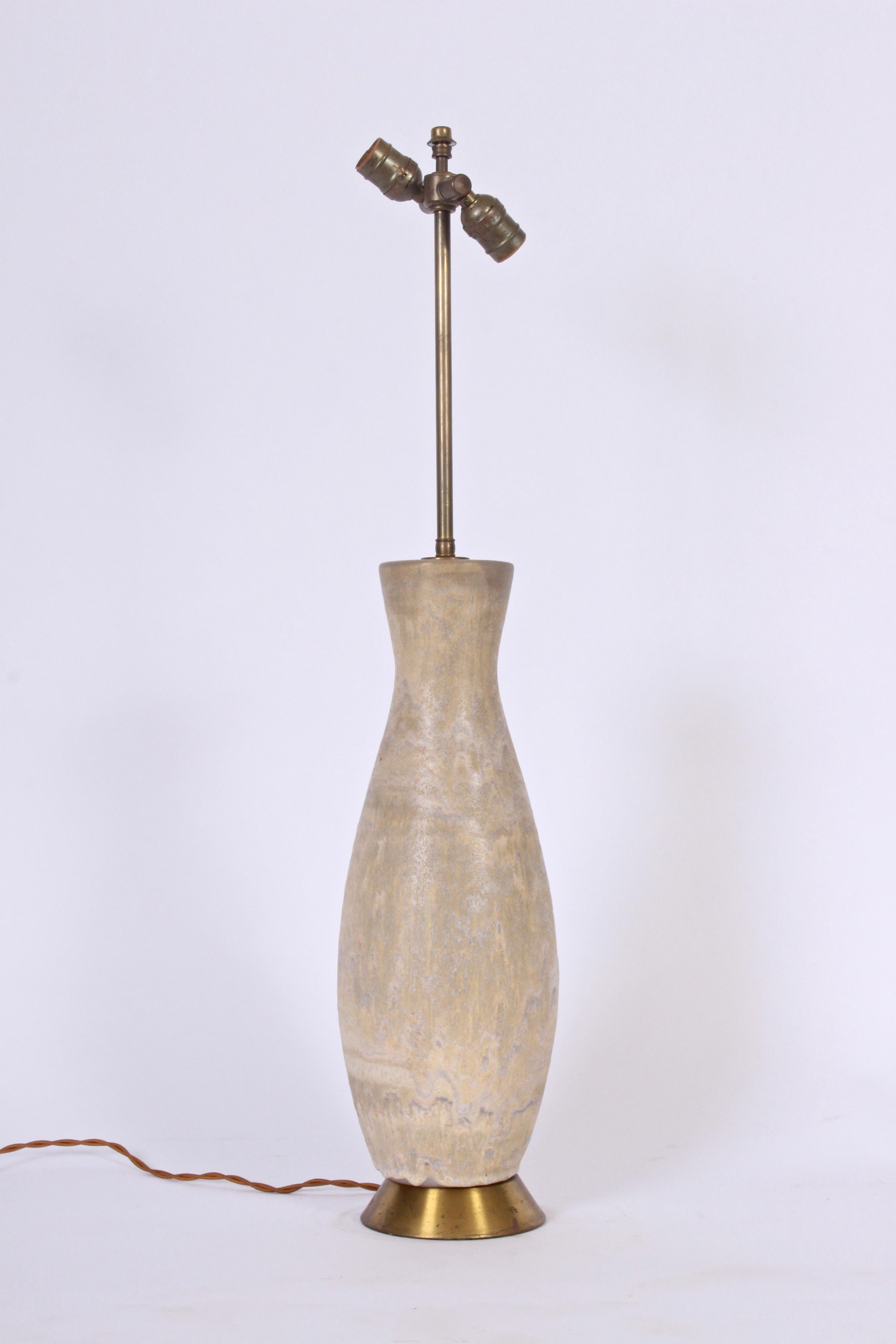 Substantial Lee Rosen for Design Technics handcrafted natural table lamp from the 1950's. Featuring a corseted bottle form with drip glaze in soft palettes of beige, pale yellow, cream, pale gray coloration, with adjustable double sockets and flared