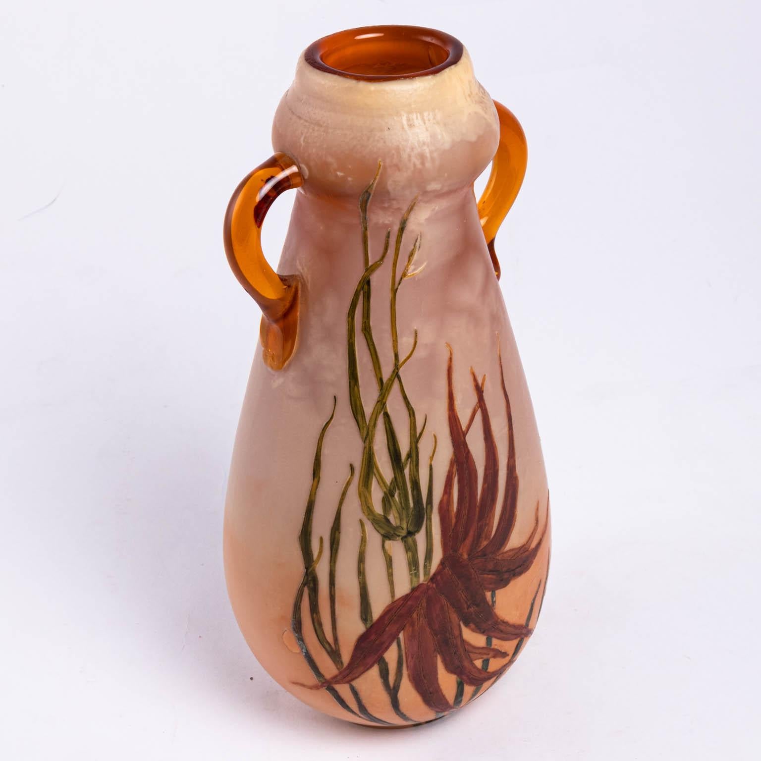 Tall Legras vase with handles in the Art Nouveau style, circa 1910s. The colors consist of amber and green. Made in France. Please note of wear consistent with age including popped air bubbles due to the manufacturing process and a small repair