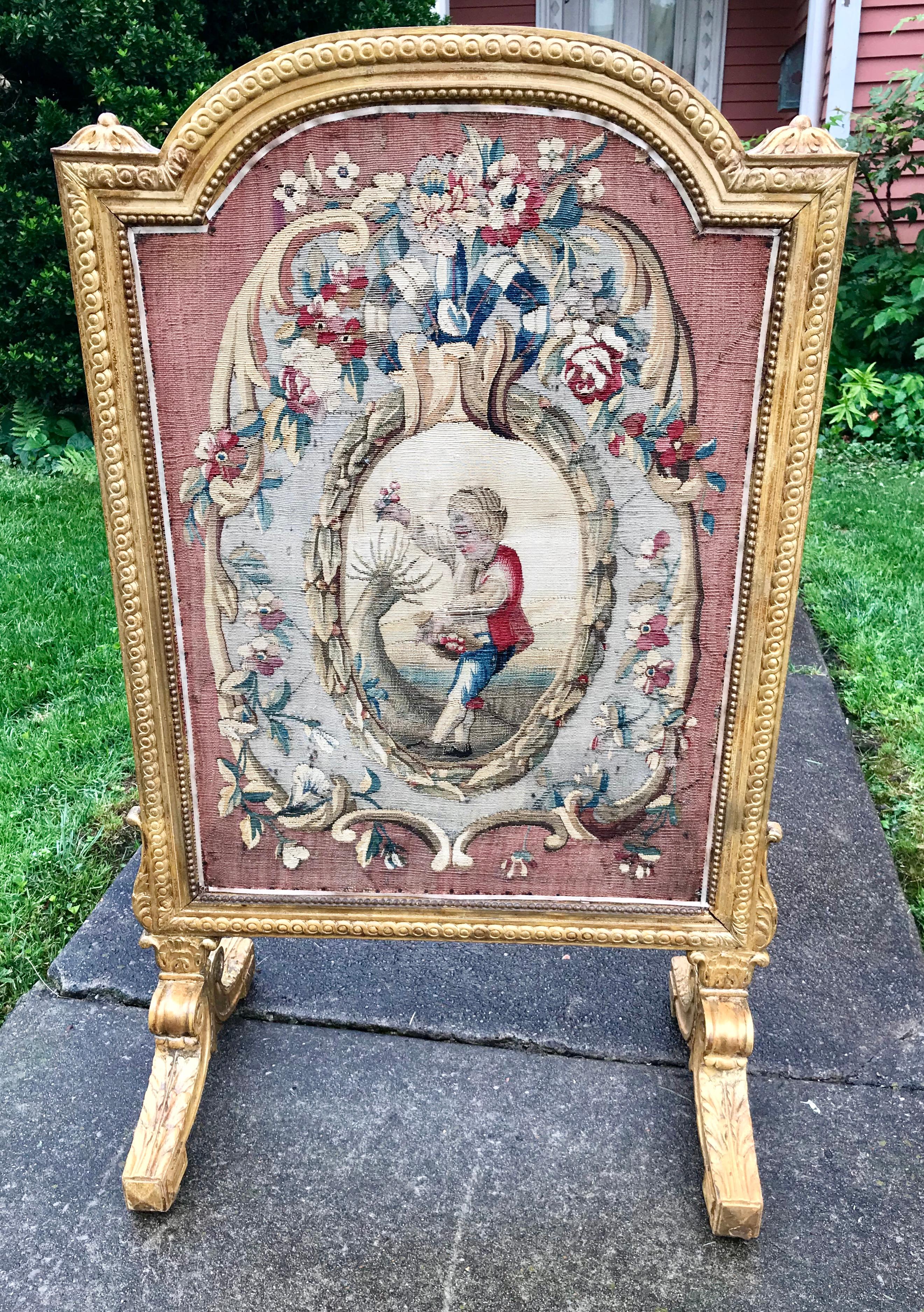 Tapestry, possibly Aubusson, probably 18th century fragment set in an 1830 carved giltwood frame. Boy picking flowers.

Back with Christies (Paris) sticker.Christies sold lot info with description and final sale price ( approx. $2049 in 2004 ).

The