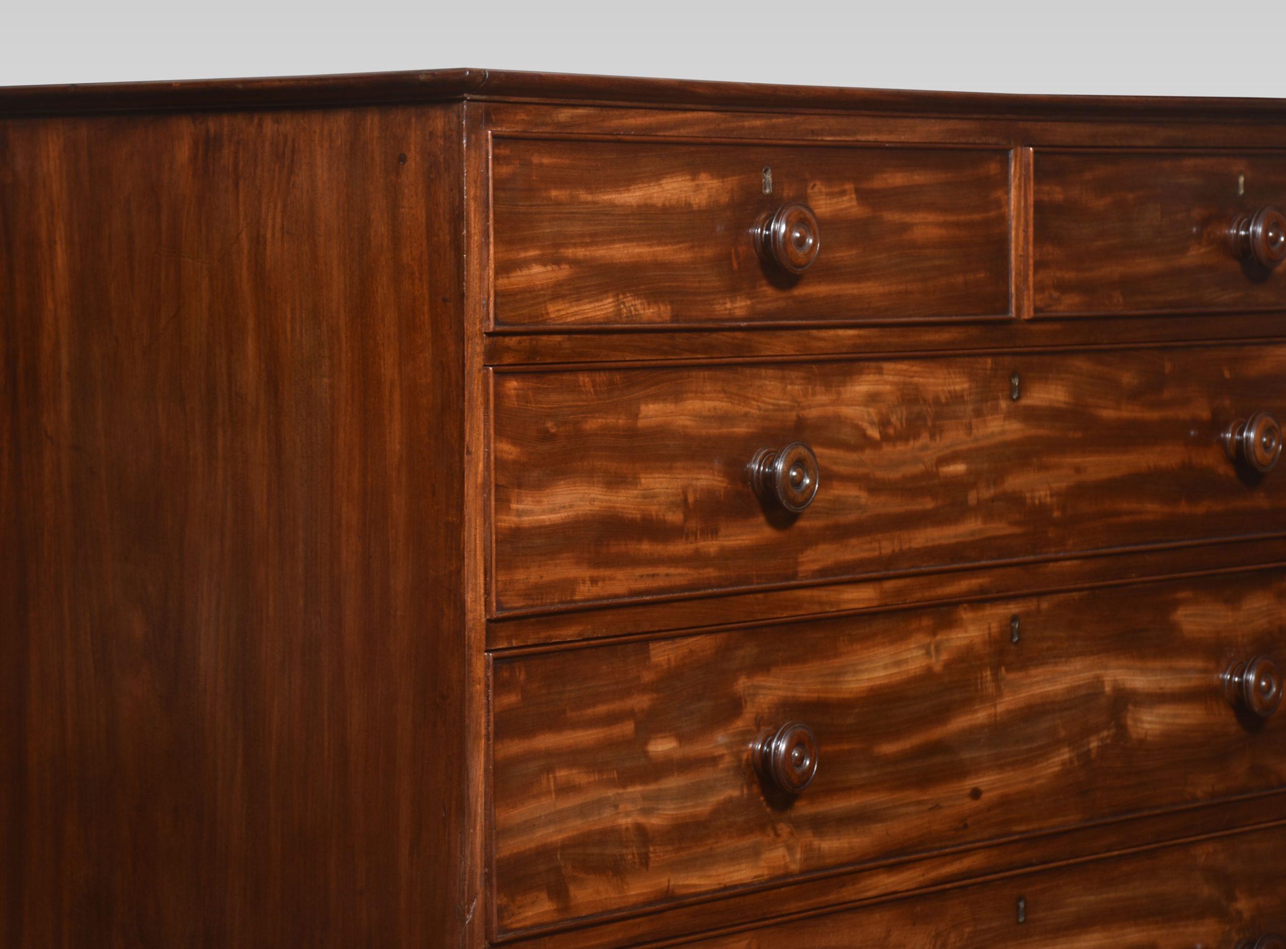 Tall mahogany chest of drawers, the rectangular top above two short and five long mahogany lined graduated drawers, all with turned mahogany knob handles. Raised up on bun feet.
Dimensions
Height 62.5 Inches
Width 54 Inches
Depth 24 Inches
