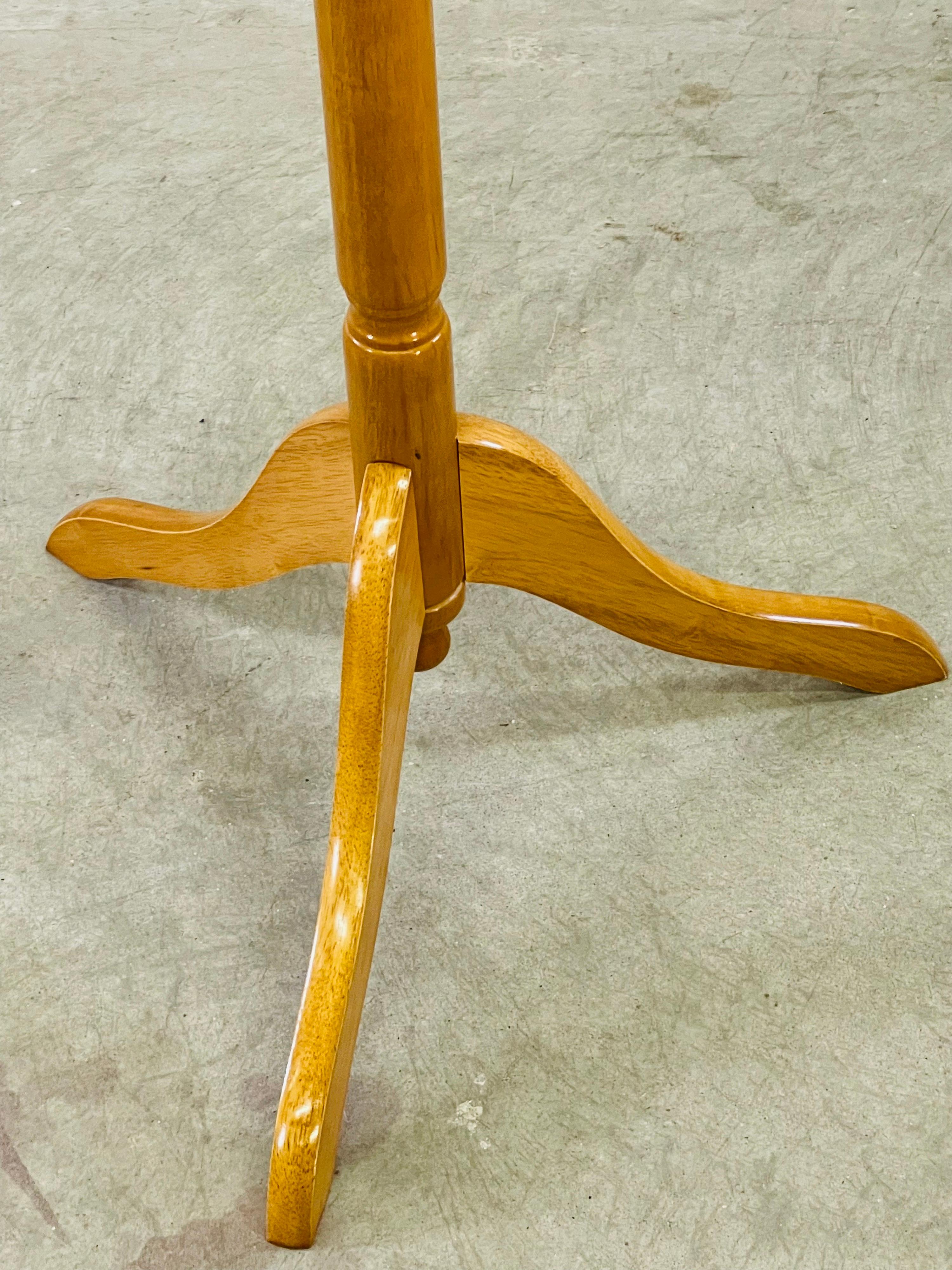 Vintage 1970s maple wood tall coat rack. The top of the rack spins and the base is a tripod style. No marks.