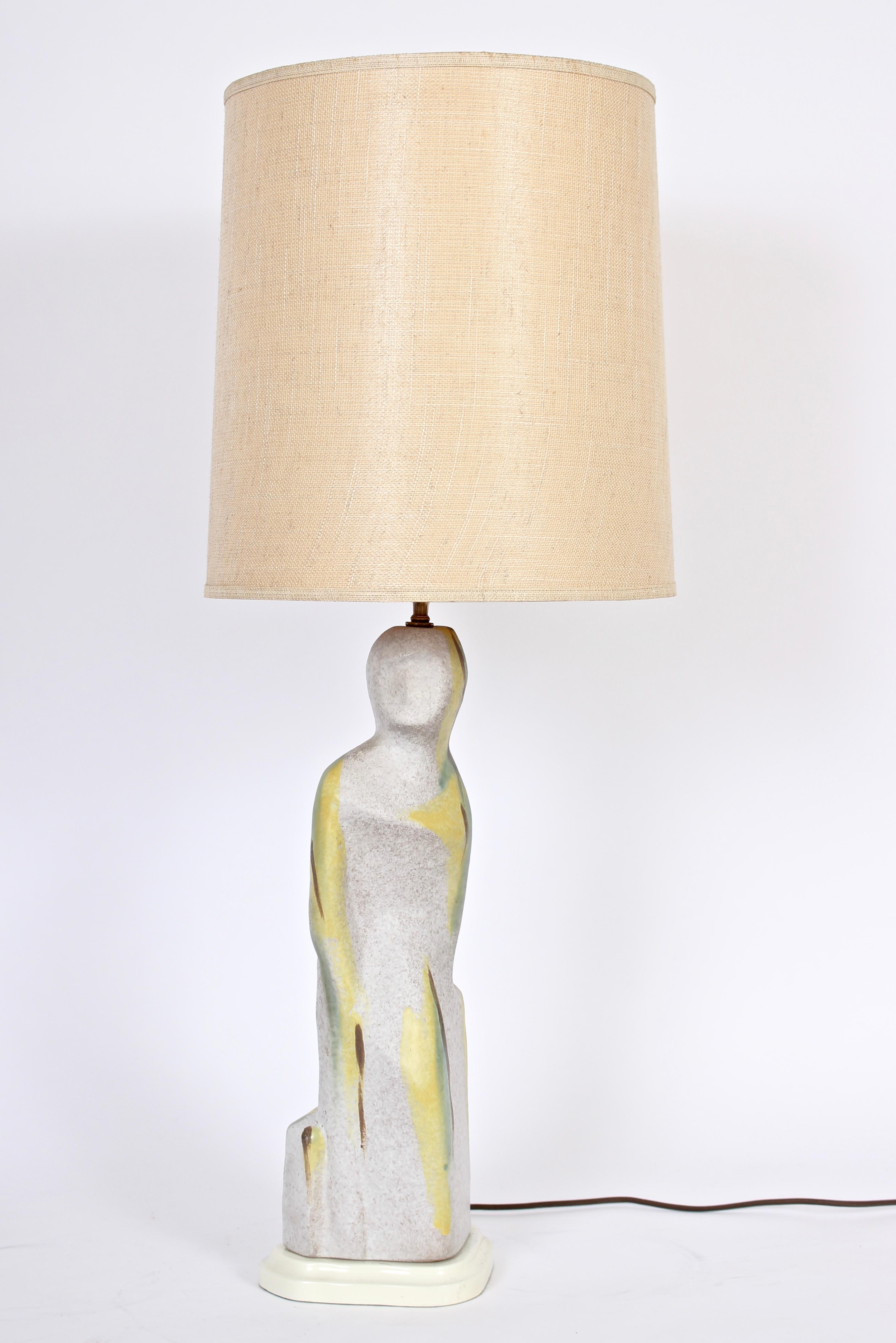 Bright handcrafted Marianna von Allesch style Cream & Yellow glazed ceramic table lamp, circa 1950. Featuring a female form, white background and pebble finish detailed with yellow, green and brown striping accents on cream lacquered wooden base.
