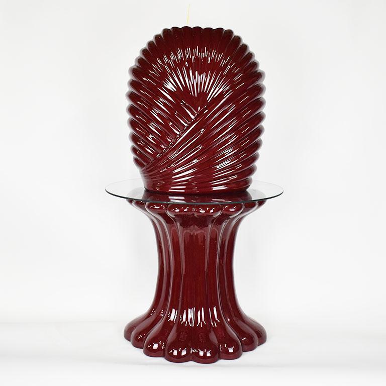 Maroon ceramic planter table with stand and glass tabletop. This unusual piece is a throwback to golden girls or designing women. The top of the piece features a striking tall ceramic vase or planter in maroon. The outside has banded overlapping