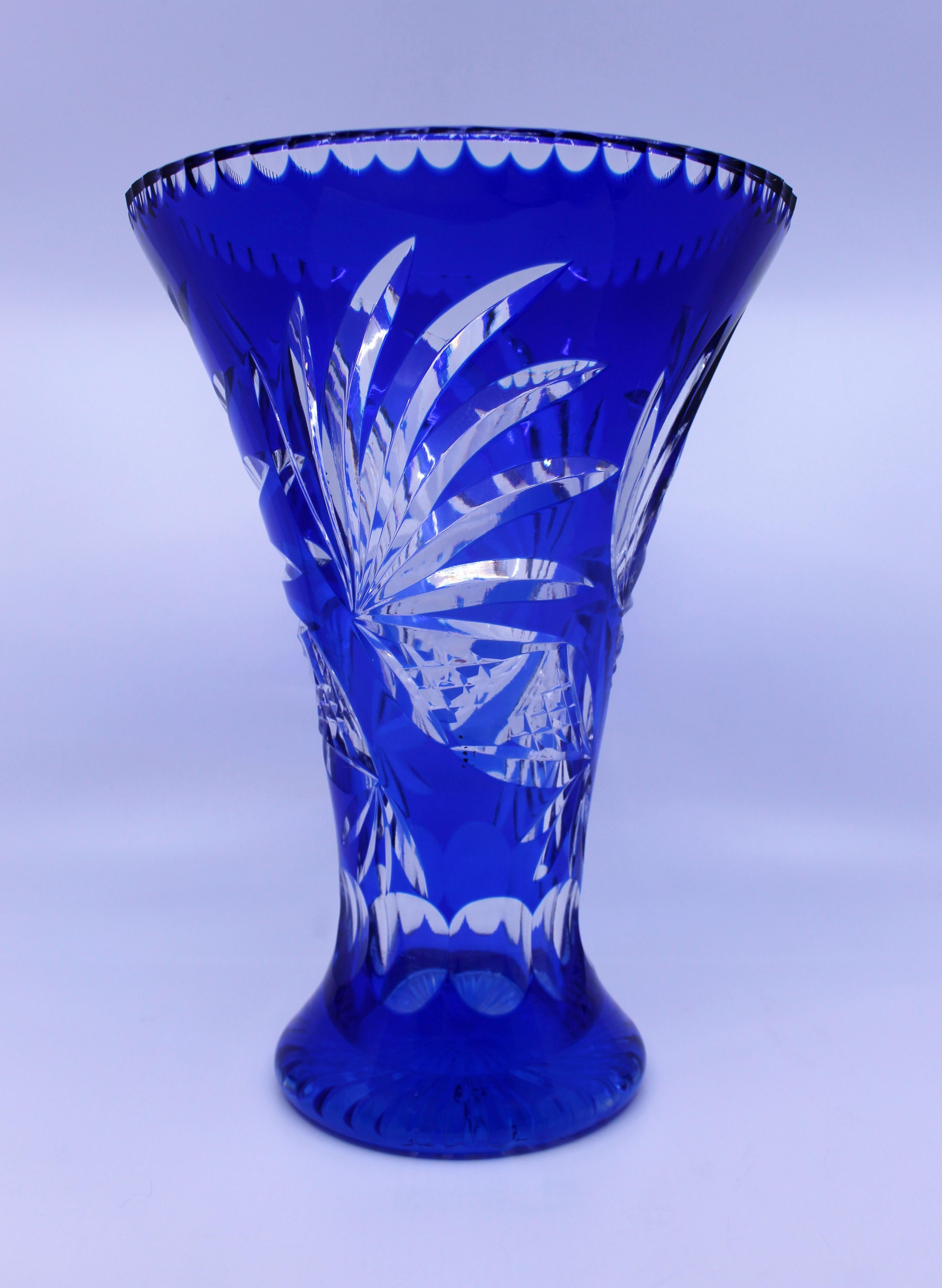 Tall mid-20th century Stourbridge blue overlay crystal flower vase

Origin 
Stourbridge, England

Composition
Cut overlay crystal, blue

Condition 
No chips, cracks or repairs. Light scratches to base commensurate with age. A small error