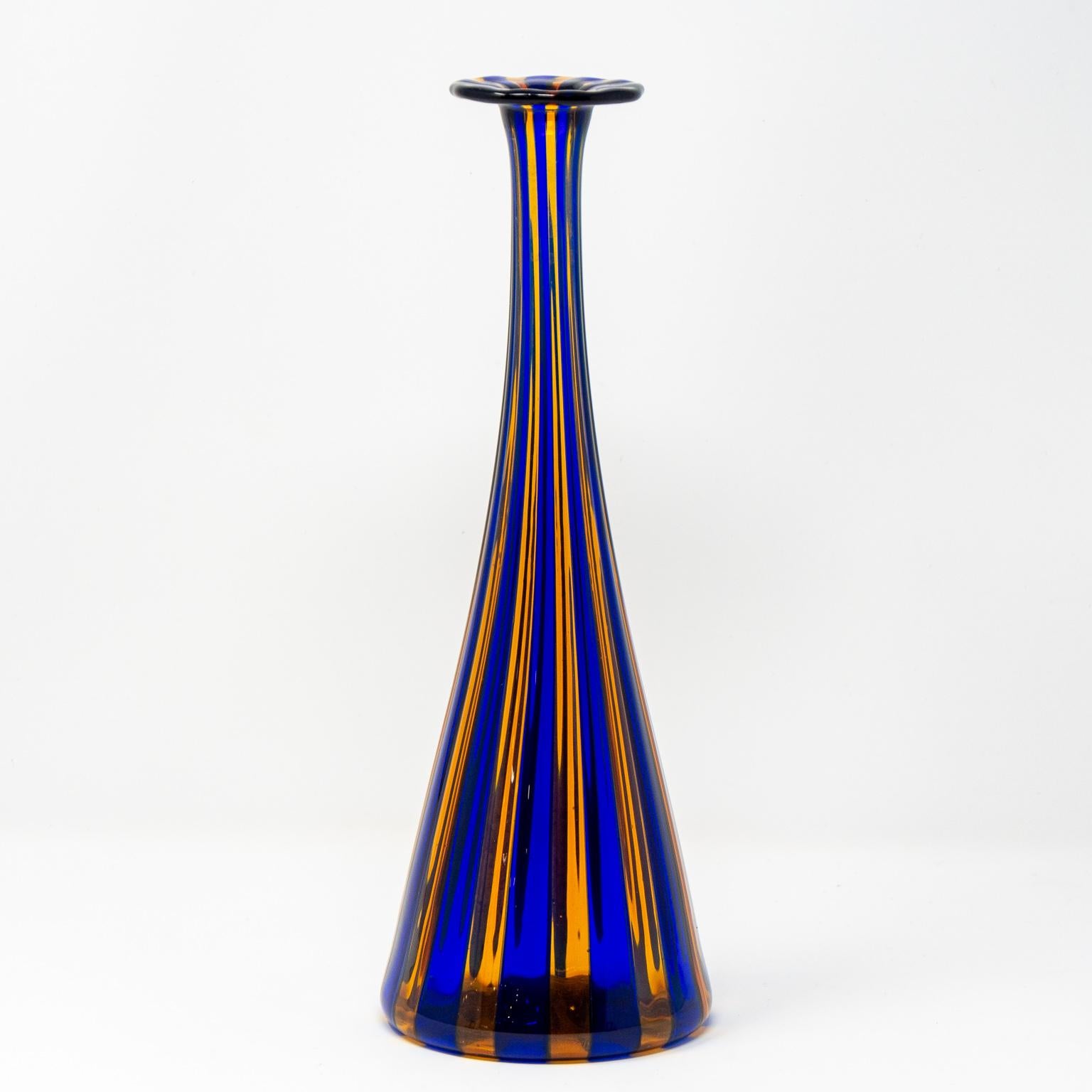 Murano glass vase is just under 11” tall and features vivid blue and orange vertical stripes, circa 1970s. No signature or maker’s mark. Another smaller version of this vase acquired at the same time from the same sources retains the original Murano