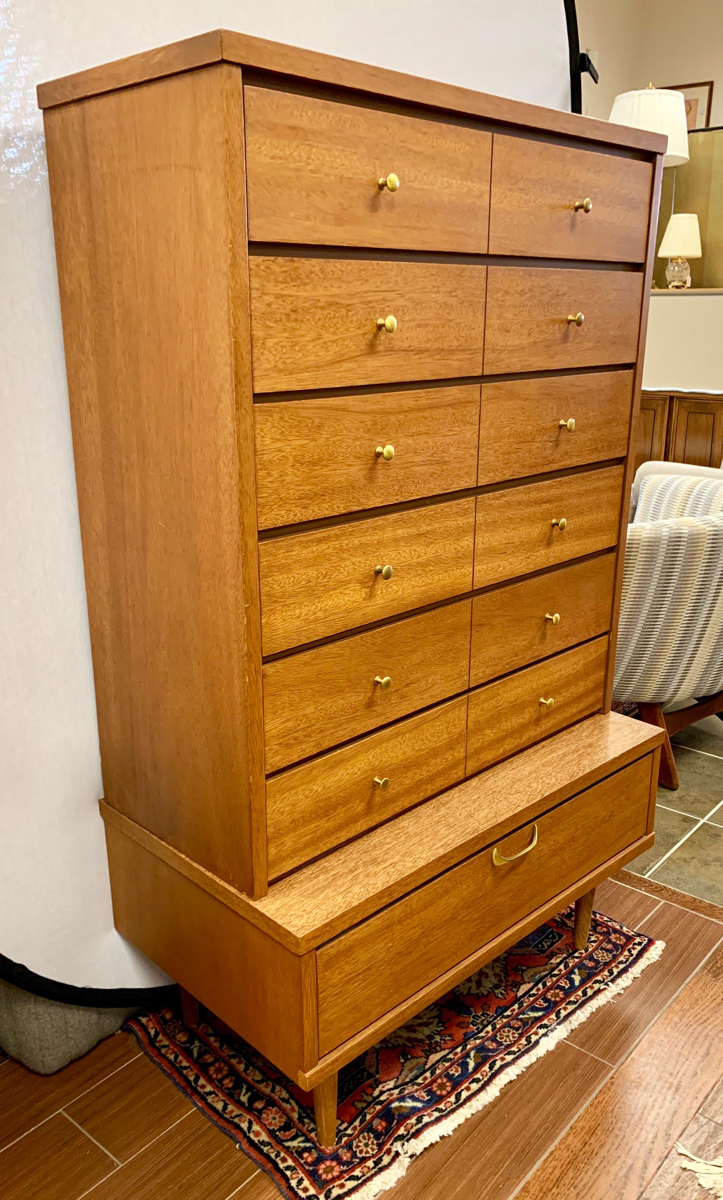 Elegant seven drawer tall mens wardrobe done with wood and veneer, circa 1960s. There are no hallmarks on the Danish Modern style chest of drawers. The lines are magnificent and the dresser comes in two pieces, a top and a bottom. There are six