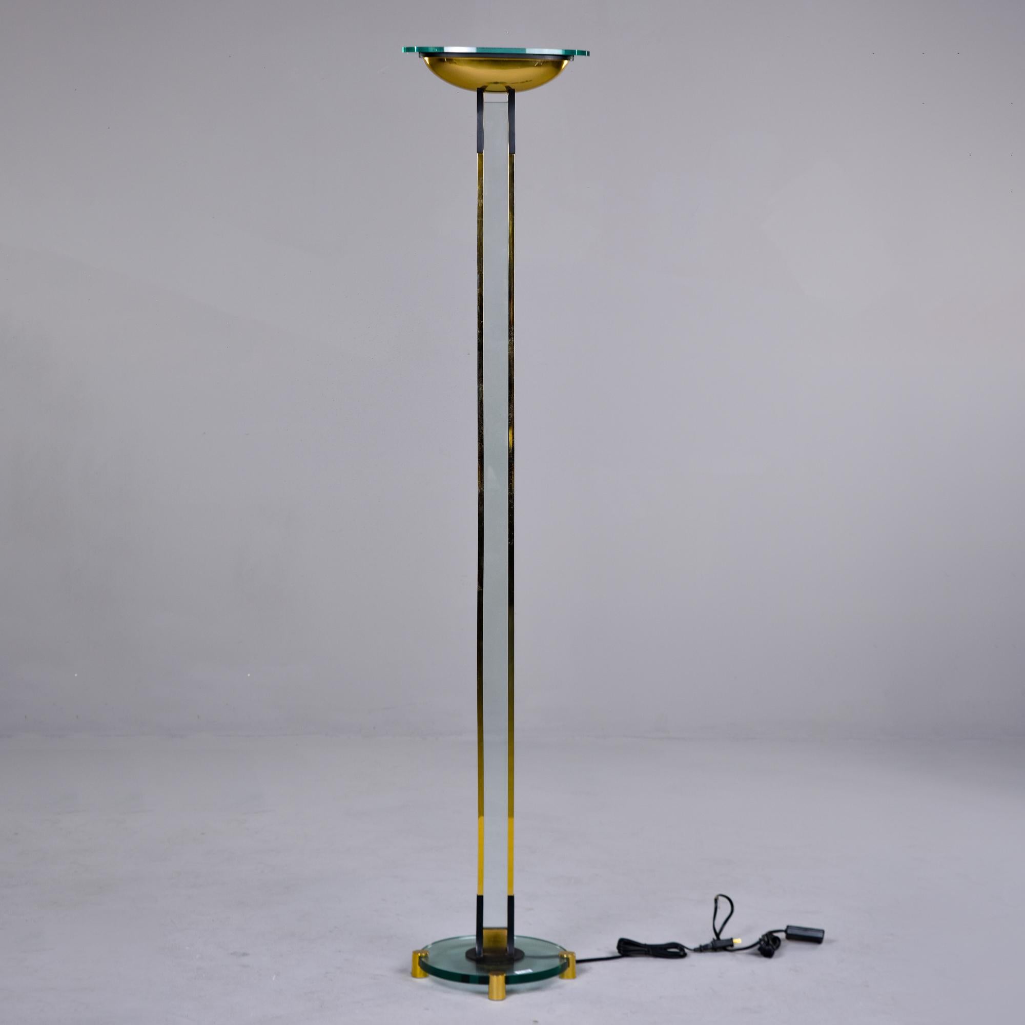 Found in Italy, this floor lamp is attributed to Fontana Arte and dates from the 1970s. Brass and chrome frame with glass accent between the two tall supports and on the base. New wiring for US electrical standards. 