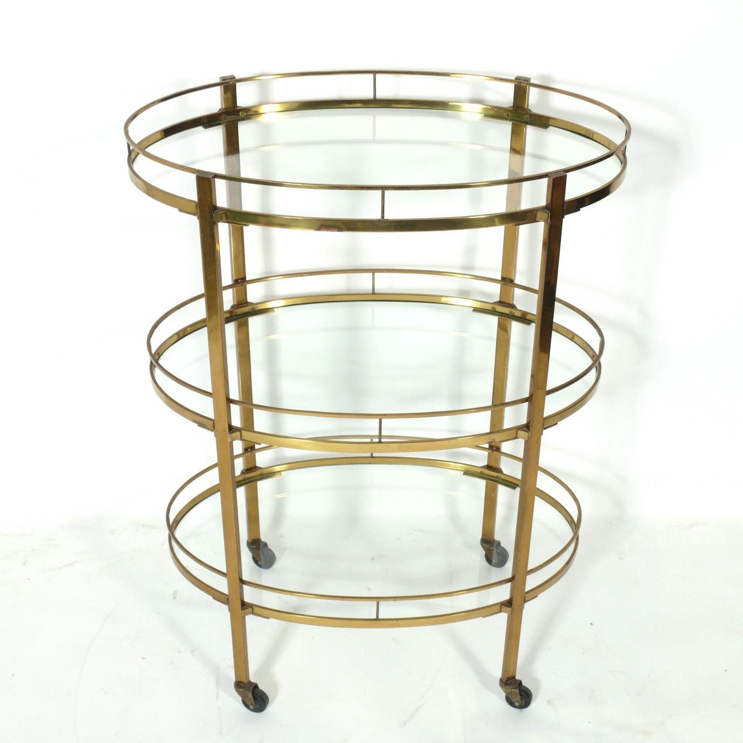 Tall mid century Italian brass bar cart, Italy, circa 1950s. We have had several of these Italian brass bar carts in the past, but never one with three tiers! It offers a voluminous amount of storage or serving capacity for your entertaining needs.