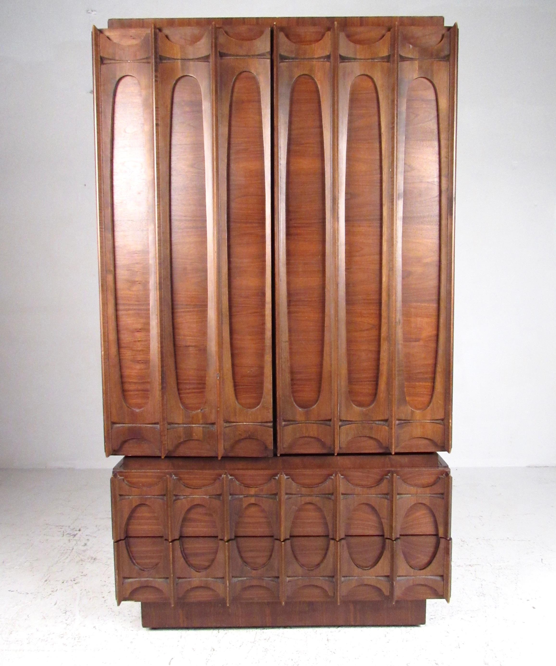 This stylish Brutalist modern armoire makes a striking midcentury addition to any bedroom set. Impressive vintage walnut dresser with spacious drawer and shelf storage for optimal bedroom organization features Brasilia style design. Please confirm