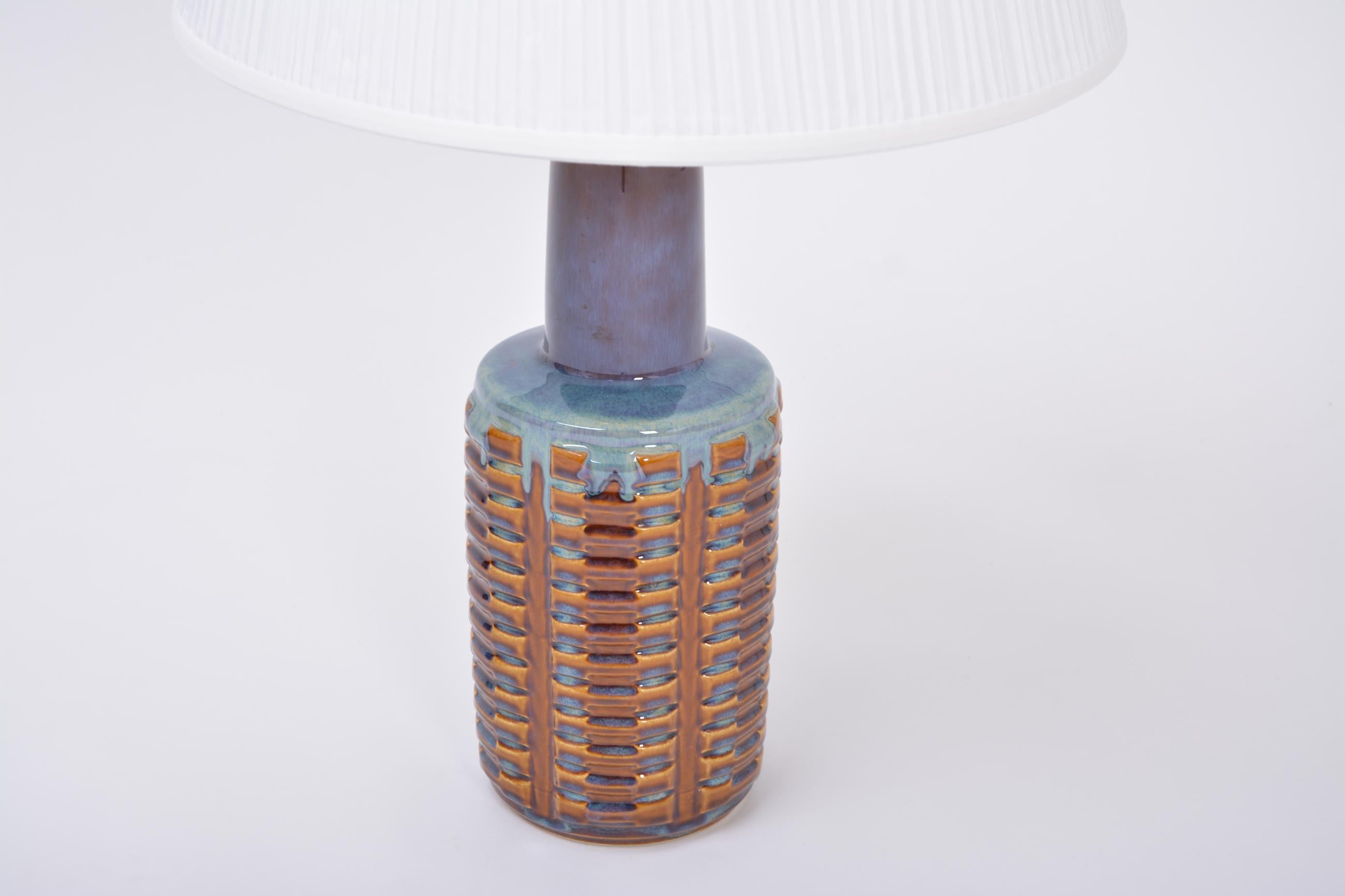 Tall Mid-Century Modern ceramic table lamp model 1023 by Einar Johansen for Soholm
This table lamp was designed by Einar Johansen and produced by Soholm Stentoj in Denmark in the 1960s. Gorgeous glazing in different colors ranging from brown to