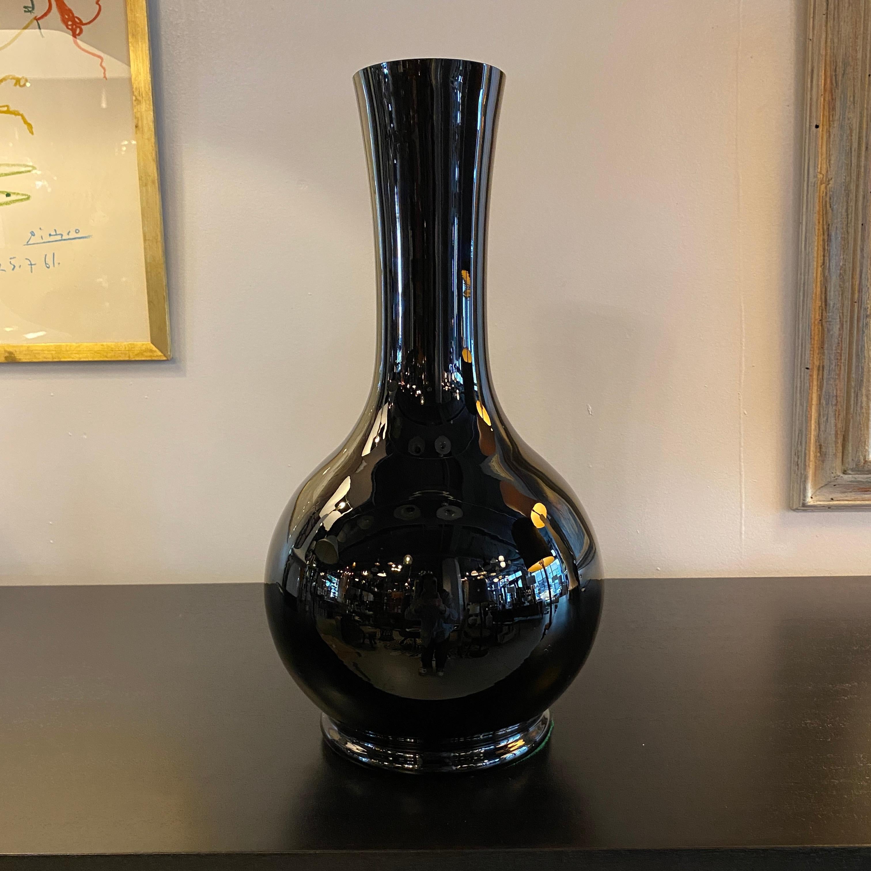 Tall, chic, mid-century, opaque ebony art glass vase with spherical base and long tapered neck. The black glass is highly reflective and glossy. It's classic shape and impressive height make this ebony art glass vase the perfect vessel for dramatic,
