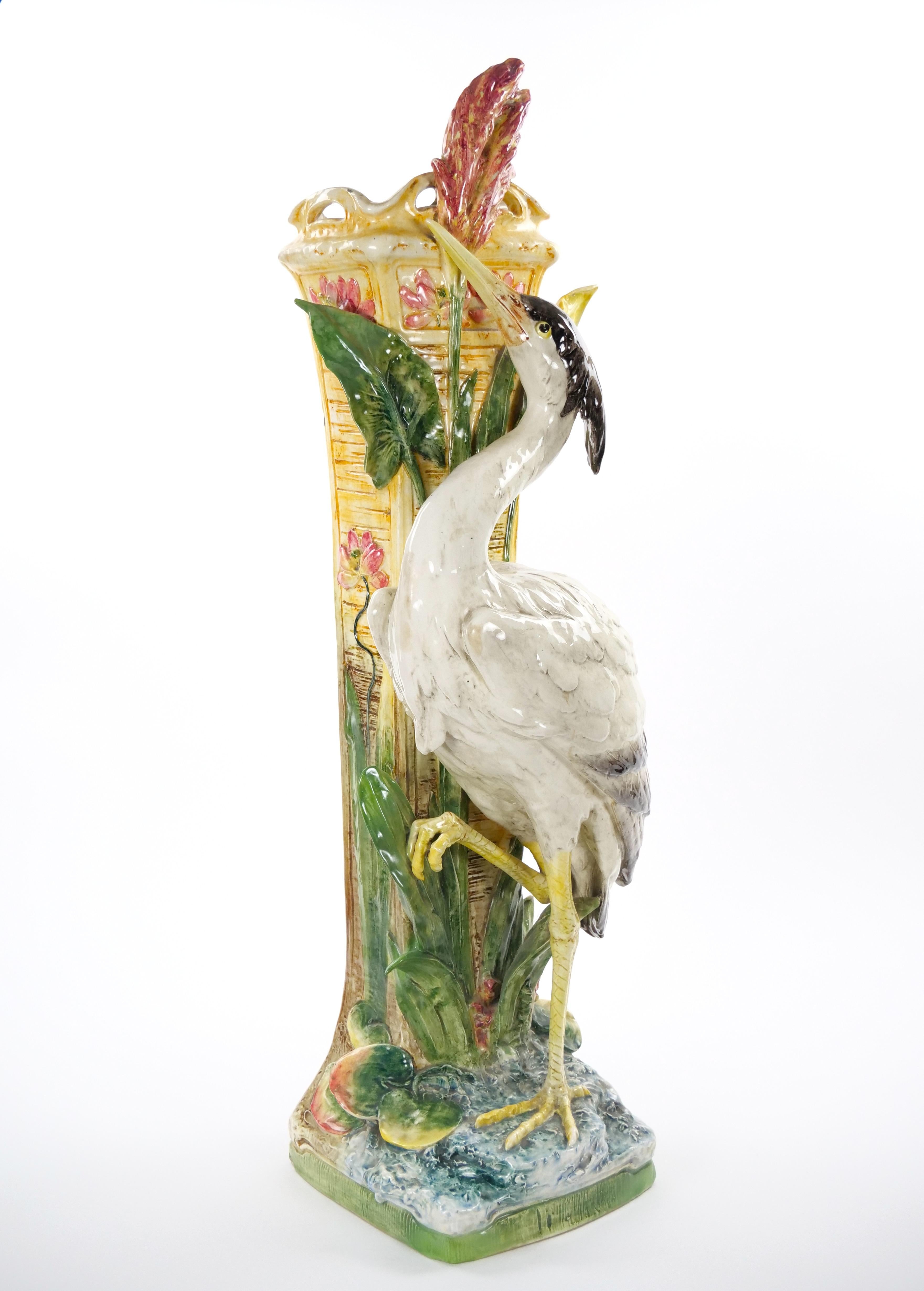 A rare and visually striking piece, this tall Mid-Century Modern decorative vase sculpture was crafted in Italy during the mid-20th century using the celebrated majolica porcelain technique. The sculptural form depicts a graceful flamingo, elegantly