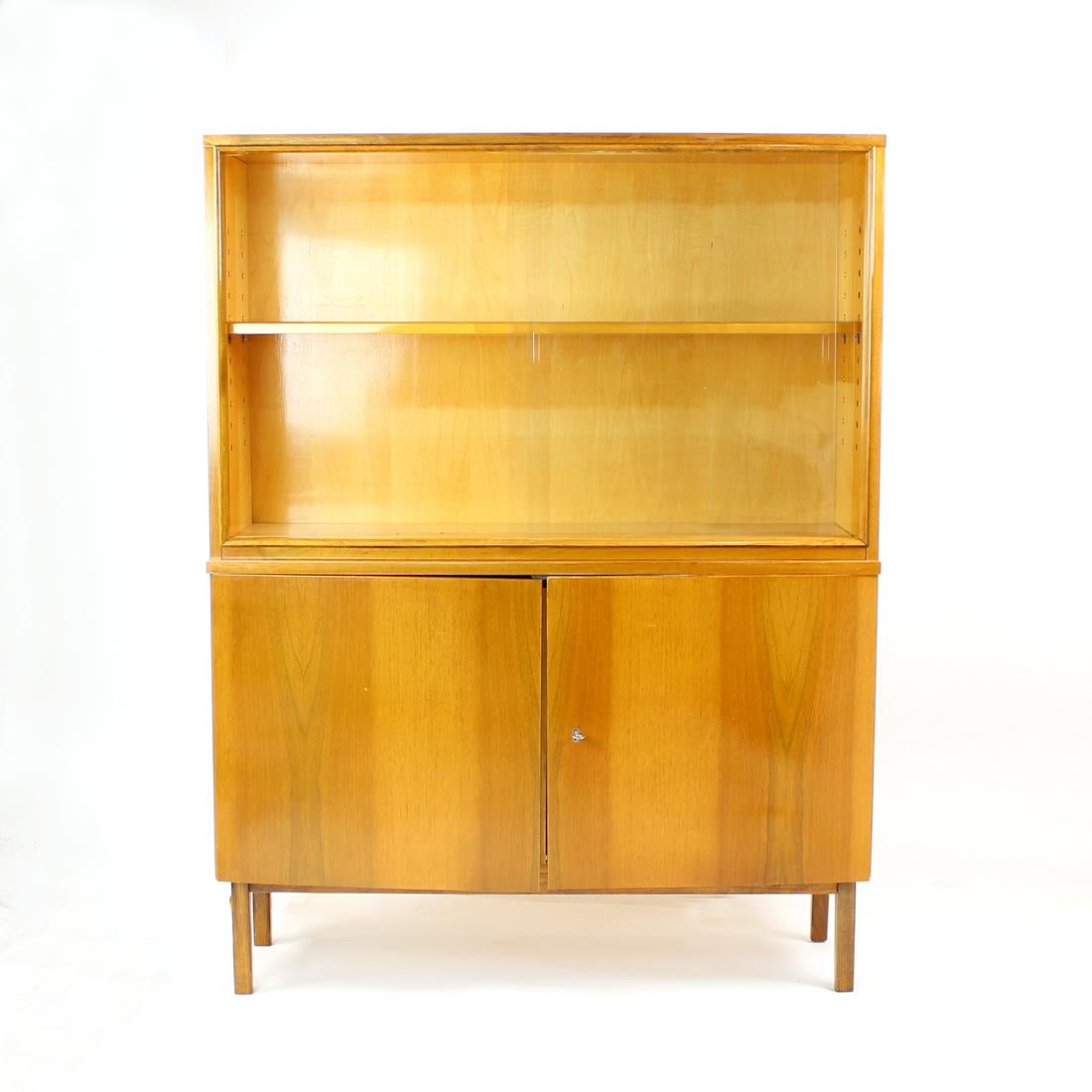 Beautiful 1960s walnut cabinet, or high sideboard. Produced in Czechoslovakia by Jitona. Made in a combination of oak wood on some parts and walnut veneer on the rest. Beautiful veneer and wood finishes. The top part has sliding glass doors,