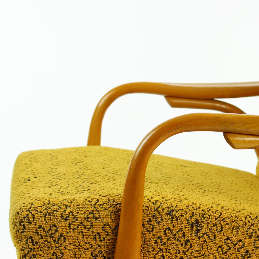 These are beautiful armchairs produced in Czechoslovakia by TON company in 1960s. The midcentury design combines lots of beautiful details on bentwood. The yellow flower print fabric is original. It is in very good condition, but shows some wear.