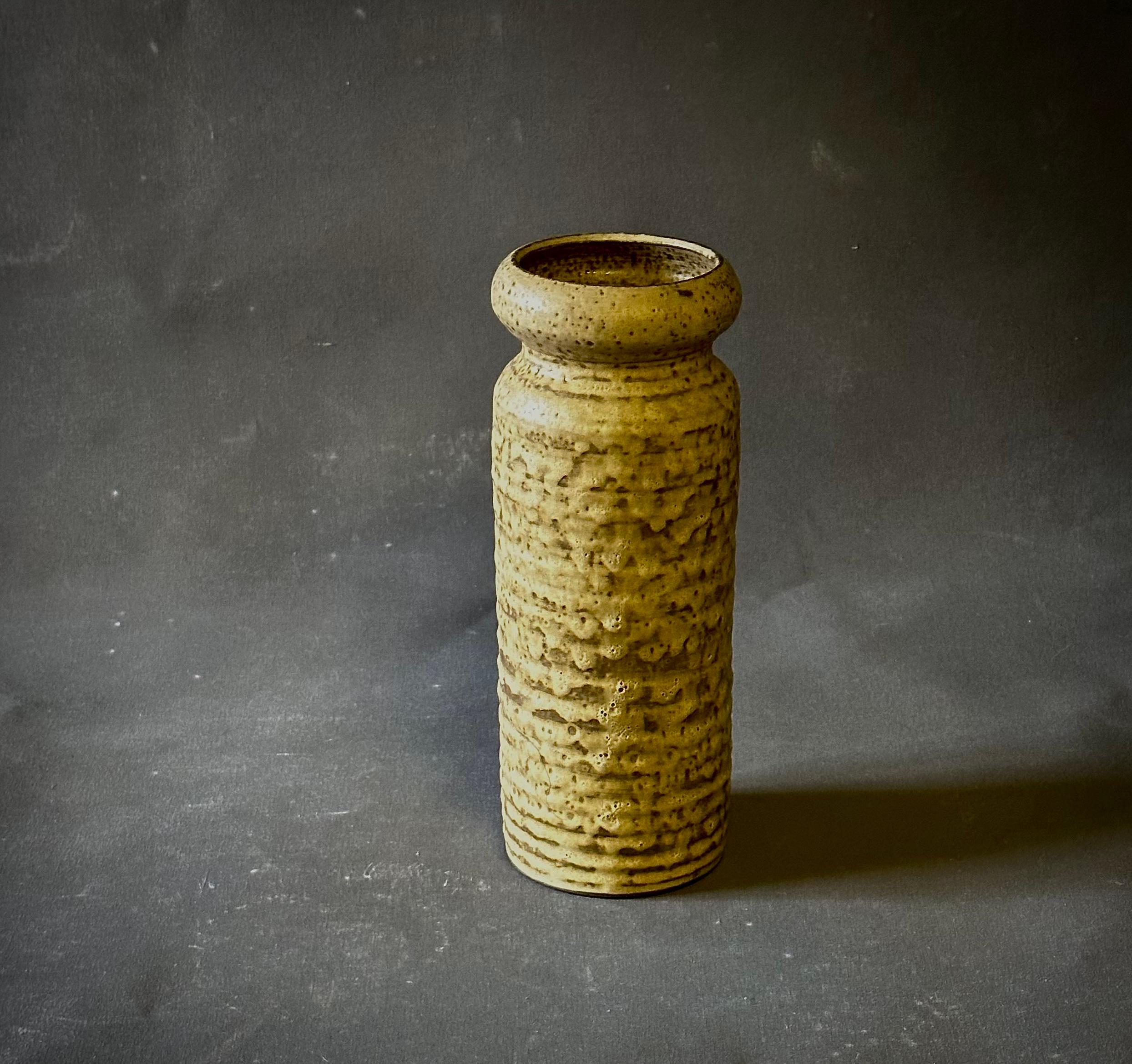 1960s Belgian textured and glazed ceramic vessel or vase in shades of golds, yellows, and browns. Would work well displayed individually or among others as part of a group. A sunny, understated piece with beautiful proportions and an exquisite
