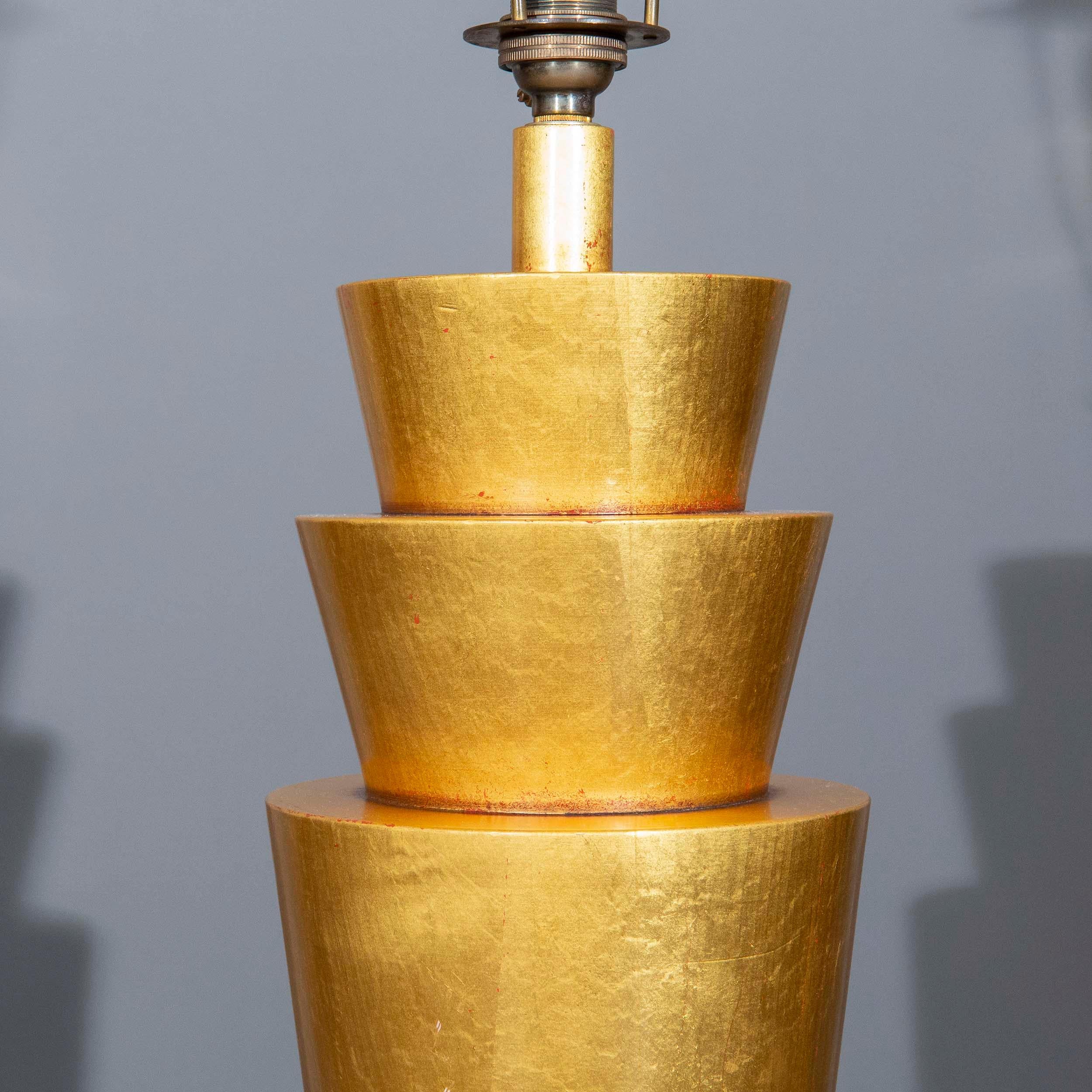 A stunning gold-leaf decorated and lacquered table lamp of large proportions, made in the Art Deco 'Egyptomania' taste in mid-20th century. France, circa 1940's–60's. Incredible opportunity to add some style and history to a classical or modern