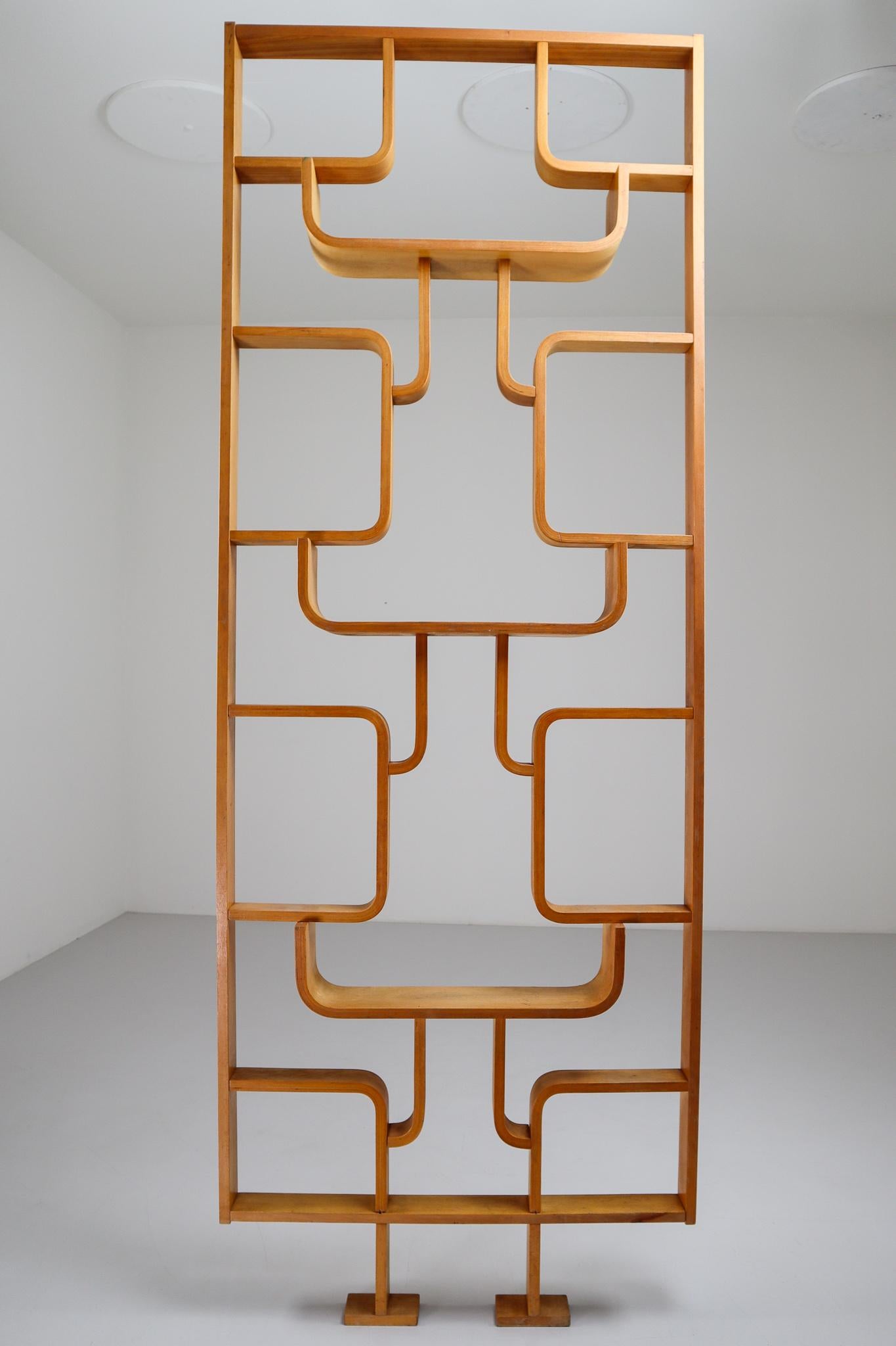 A unique 1960s piece of Czech design, part of a limited five year production. Can be used as a wall-mounted shelving unit or room divider. Square edges in blond color plywood and features geometric patterns. Designed by Ludvik Volak in the Czech