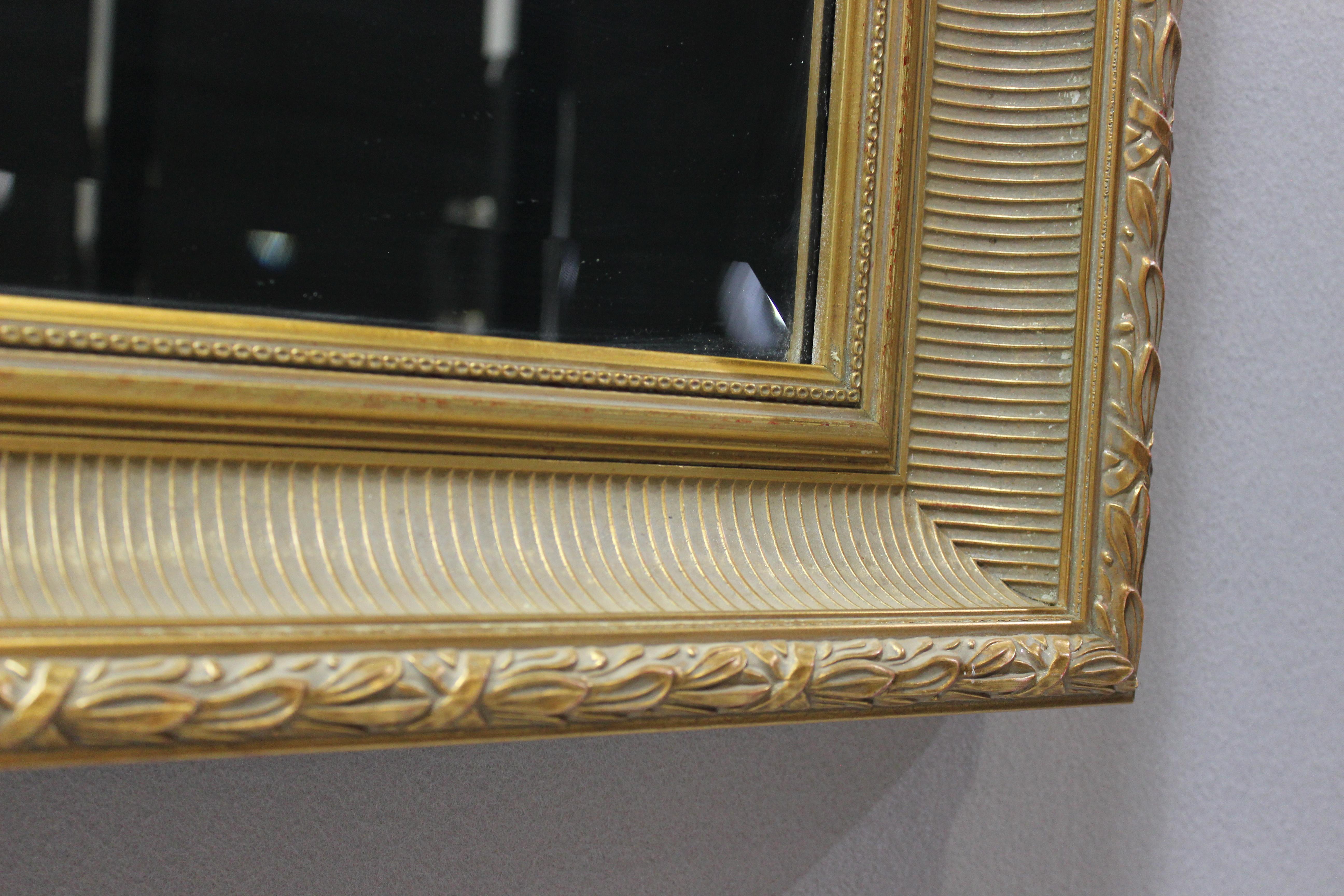 Italian Renaissance mirror - gilded wood over rouge royal - beveled glass -.