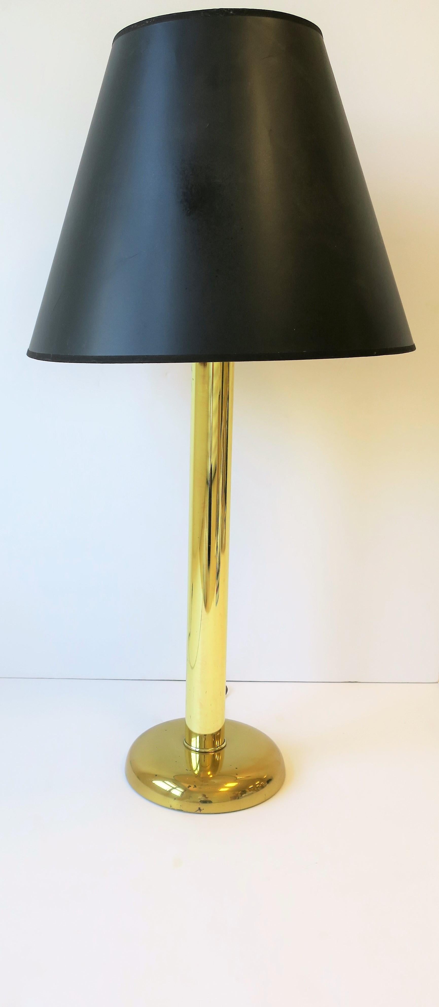A tall modern style brass-plated table lamp with black paper shade, circa 1970s. 

Lamp measurements: 
8 in. diameter base x 31.5 in. to top of finial or 21.5 to top of lamp's body (just below socket.)

 