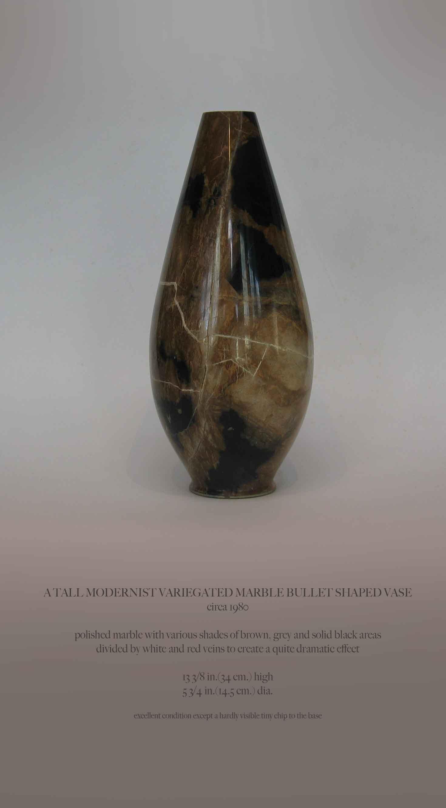 A TALL MODERNIST VARIEGATED MARBLE BULLET SHAPED VASE
circa 1980

Polished marble with various shades of brown, grey and solid black areas
divided by white and red veins to create a quite dramatic effect.

13 3/8