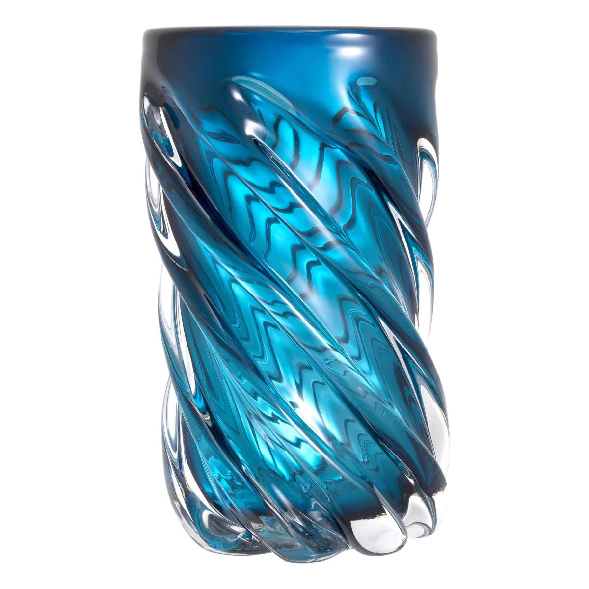 Tall, mouth-blown blue glass vase.

Prettily shaped for displaying colorful floral arrangements, this large blue vase is a functional and elegant addition to your home decor.
Handcrafted from yellow glass, it features an elegant swirl pattern.
Each