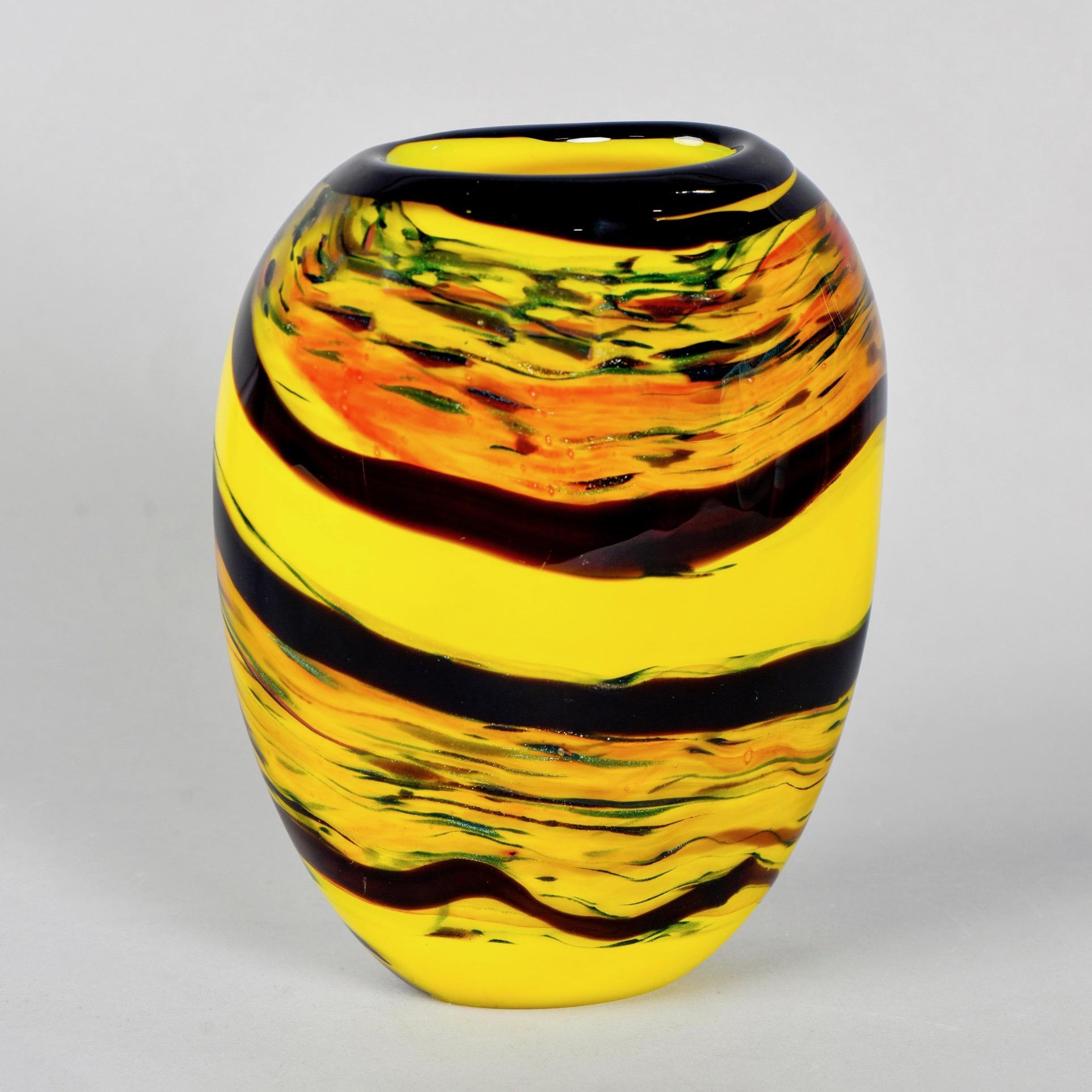 Murano glass vase in bold shades of yellow and gold with wavy black bands and a black rim, circa 2017.
     