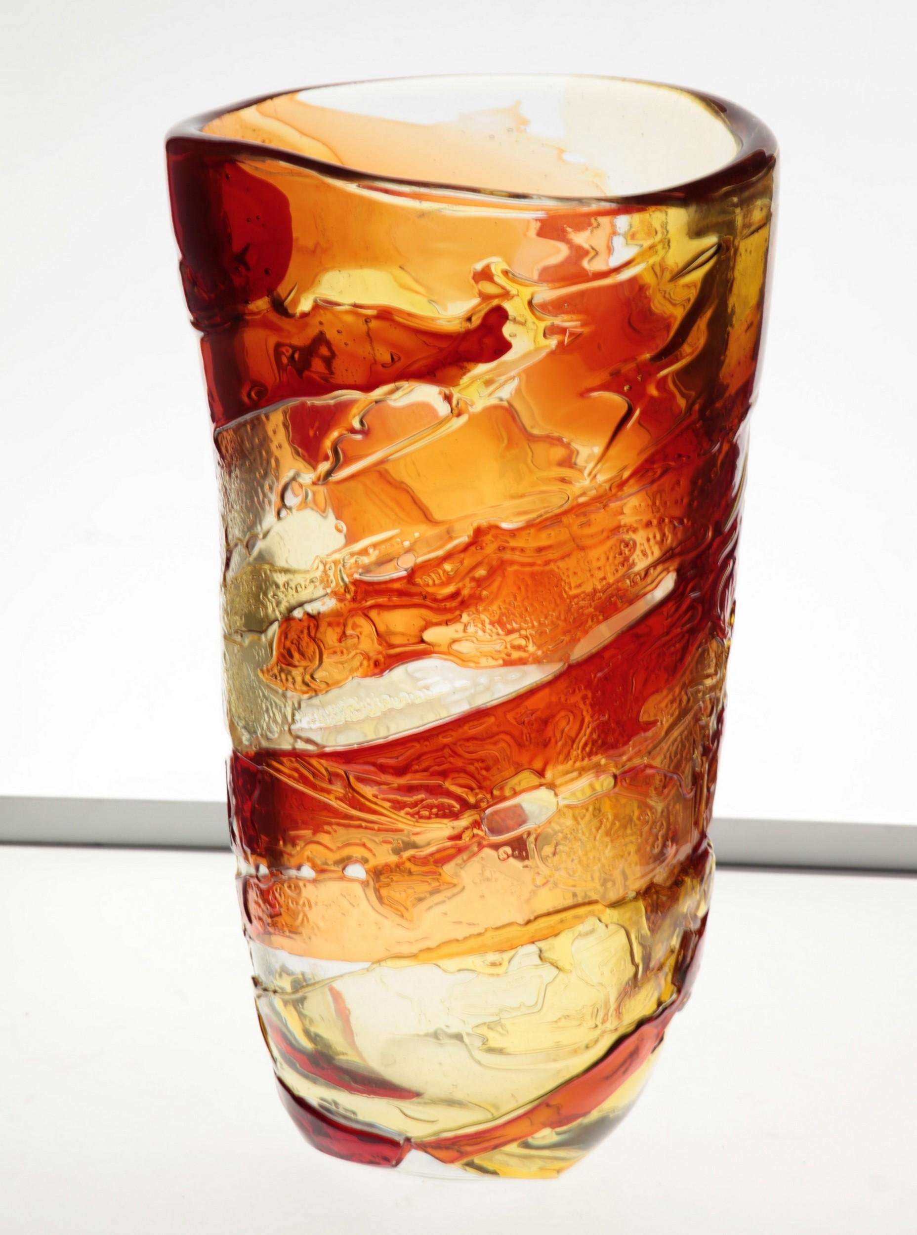 Striking heavy glass with decoration called sbruffi. This decoration is the same that is used to do Sommerso vase. This requires a team of two blowers. One holding the glass vase and the other blowing on it another glass of a different color. The