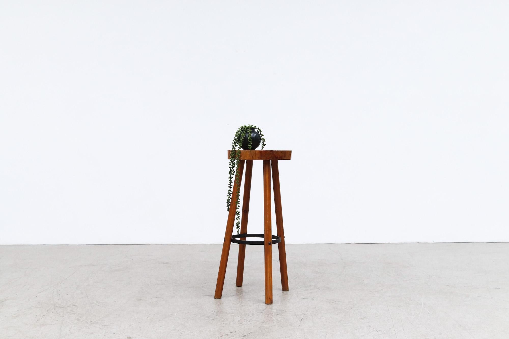 Tall Nakashima inspired bar stool with a beautiful live edge tree trunk slice top, thick wood legs and iron footrest. In original condition with wear consistent with its age and use.