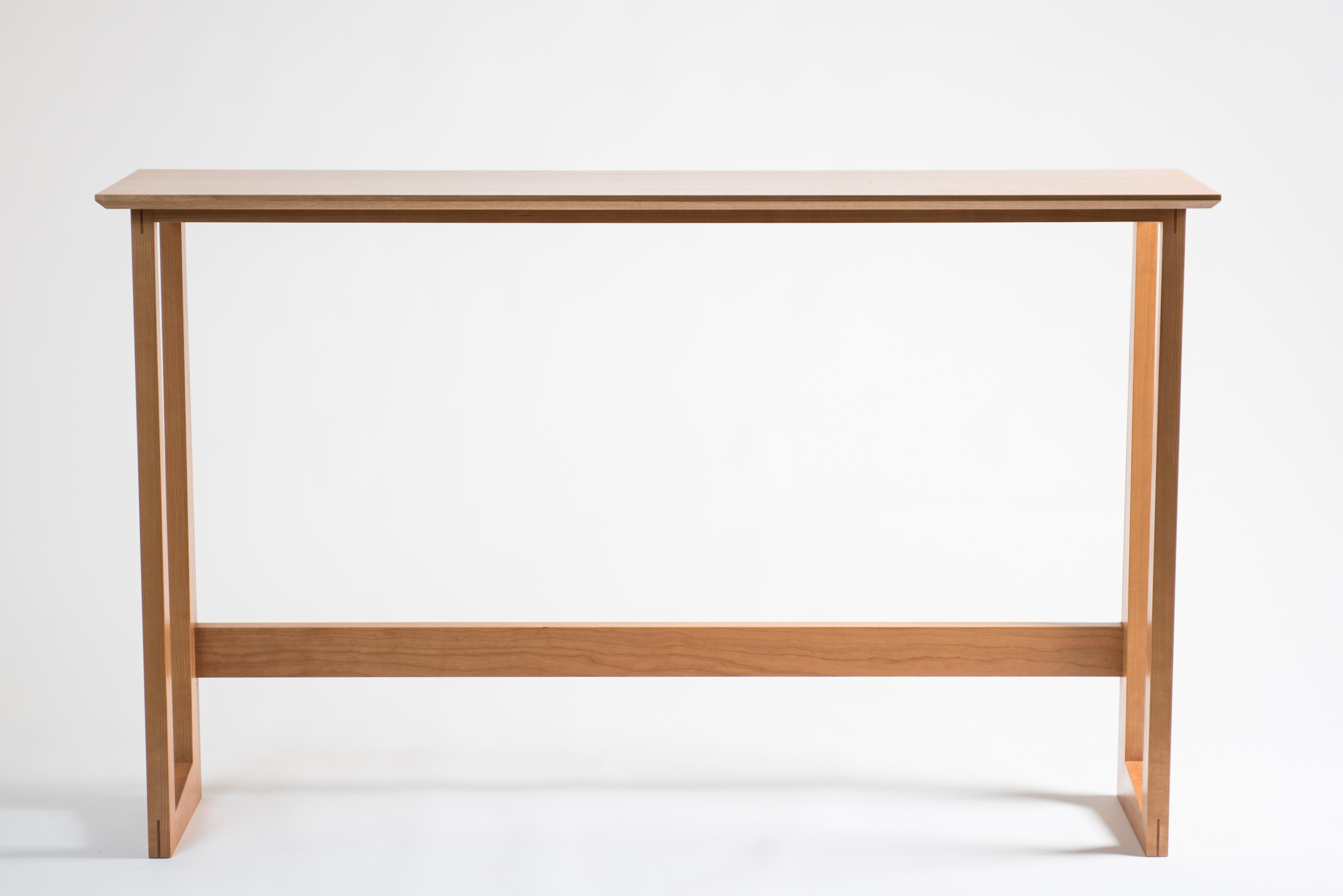The Westport Pub table is a simple, sturdy table that would sit well in a house or apartment, as a standing desk behind a couch or as a breakfast bar by a kitchen window. The leg design plays on the traditional miter with varying angles and widths.