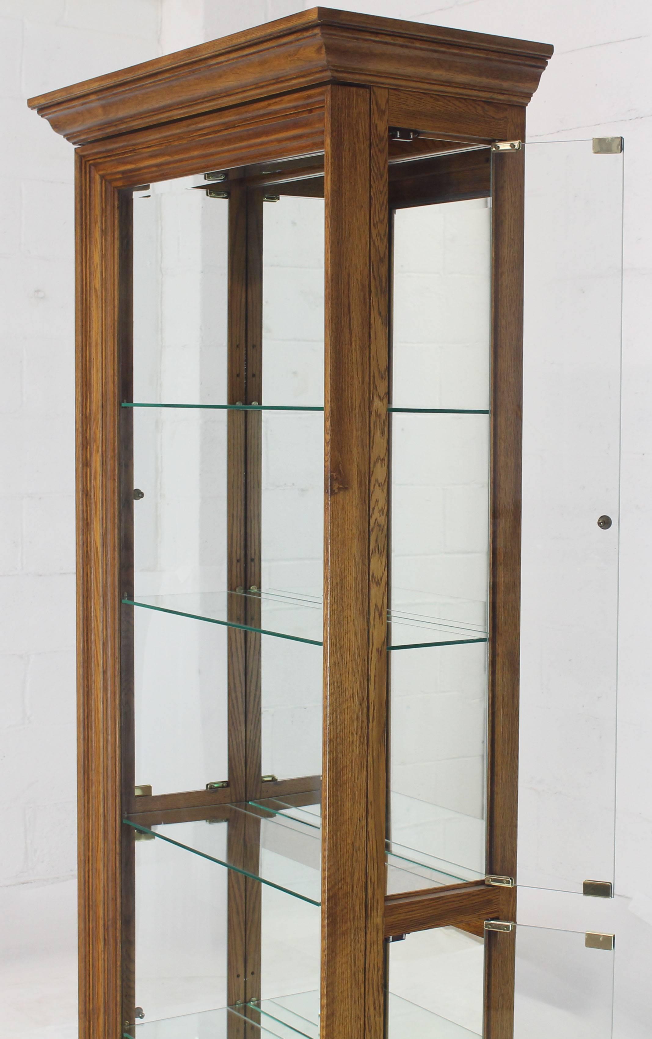 tall narrow display cabinet with glass doors