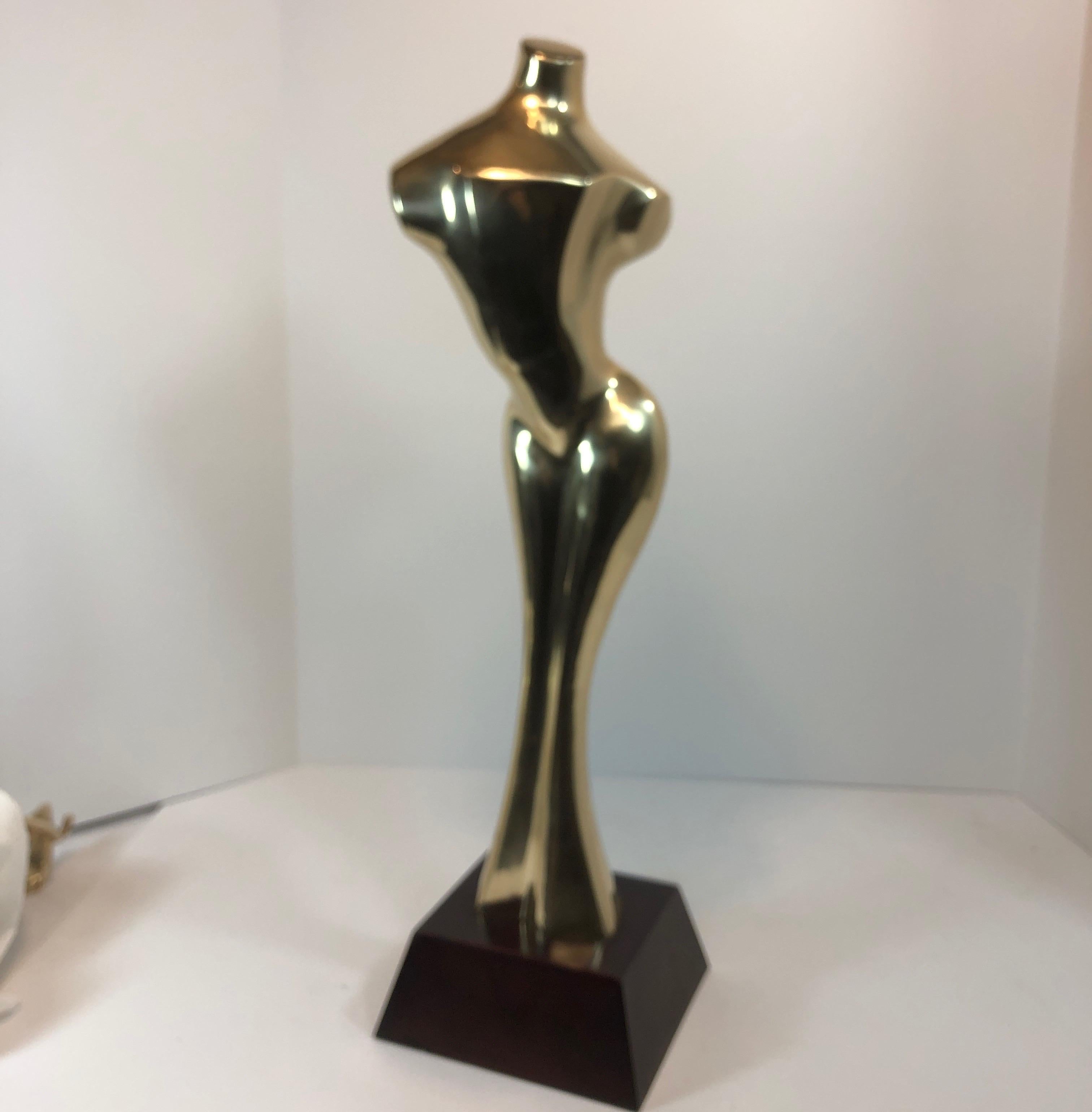 Tall nude curvy female brass sculpture on wood stand. Has great shape. Hand polished, could be machined polished for an amazing finish. Made in Italy by Decorative Crafts Inc. Label on underside.