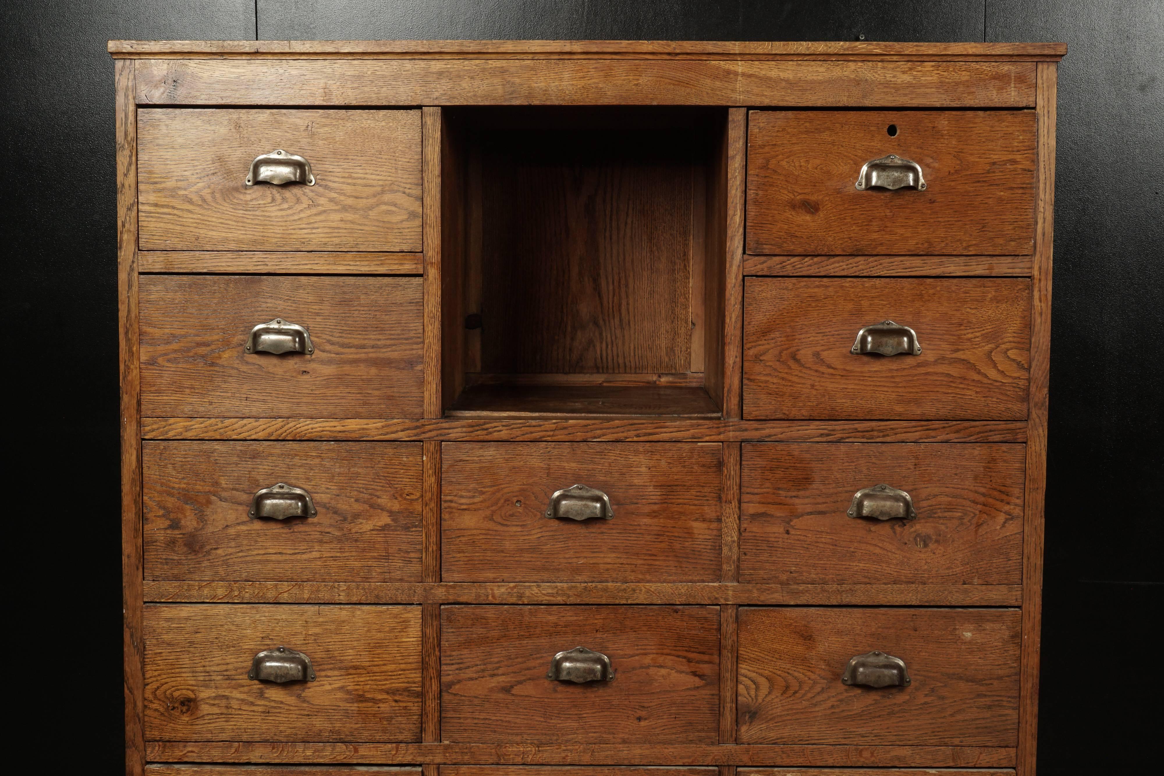 Tall oak chest of drawers from France, circa 1940. Solid oak construction with original hardware.