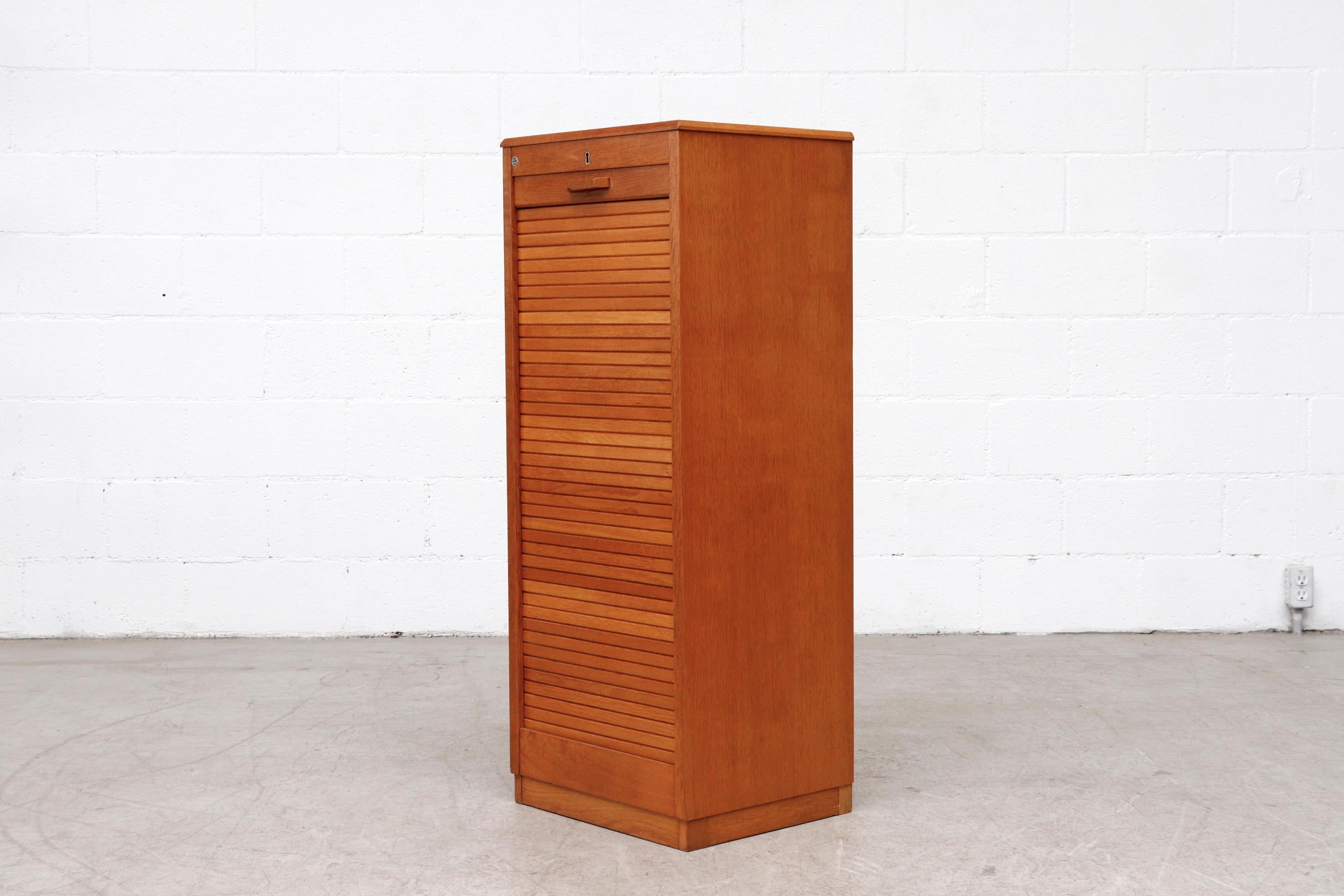 Tall Eeka file cabinet with Locking Tambourd door. And stacking birch drawers inside. In good original condition with some signs of wear consistent with it's age and use. Other similar ones available, listed separately. (LU922418963012,