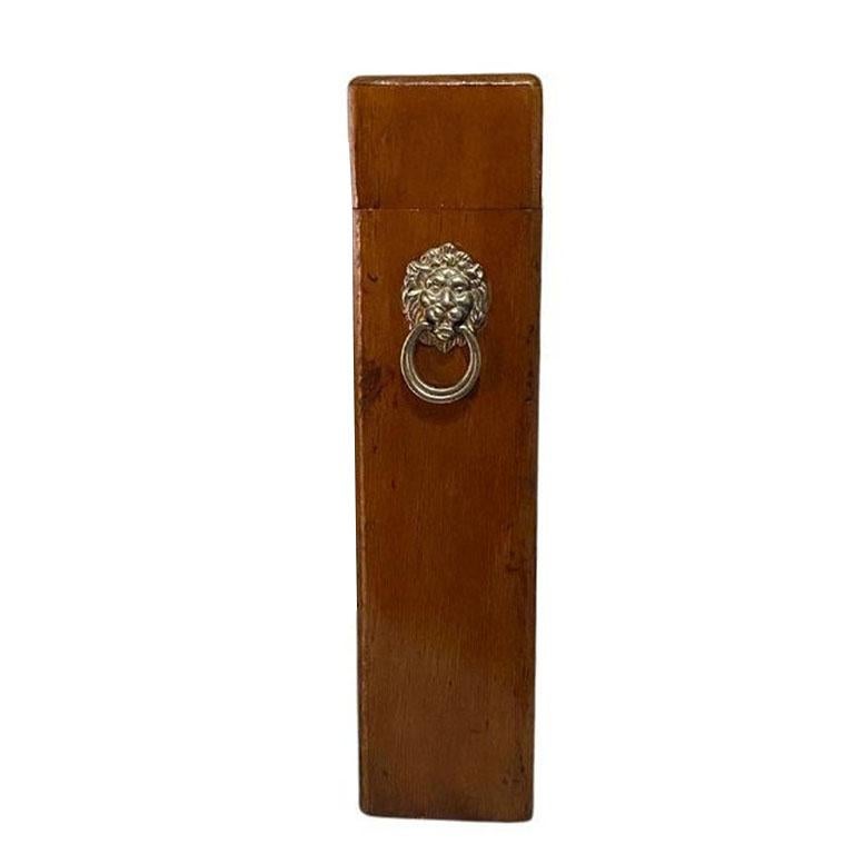 A tall wooden Oak fireside matchbox with a lid. A fabulous detail to add to a mantle or near a fireplace. This tall brown box features a hinged lid and a golden metal lion head with a ring pull. 

Dimensions:
13