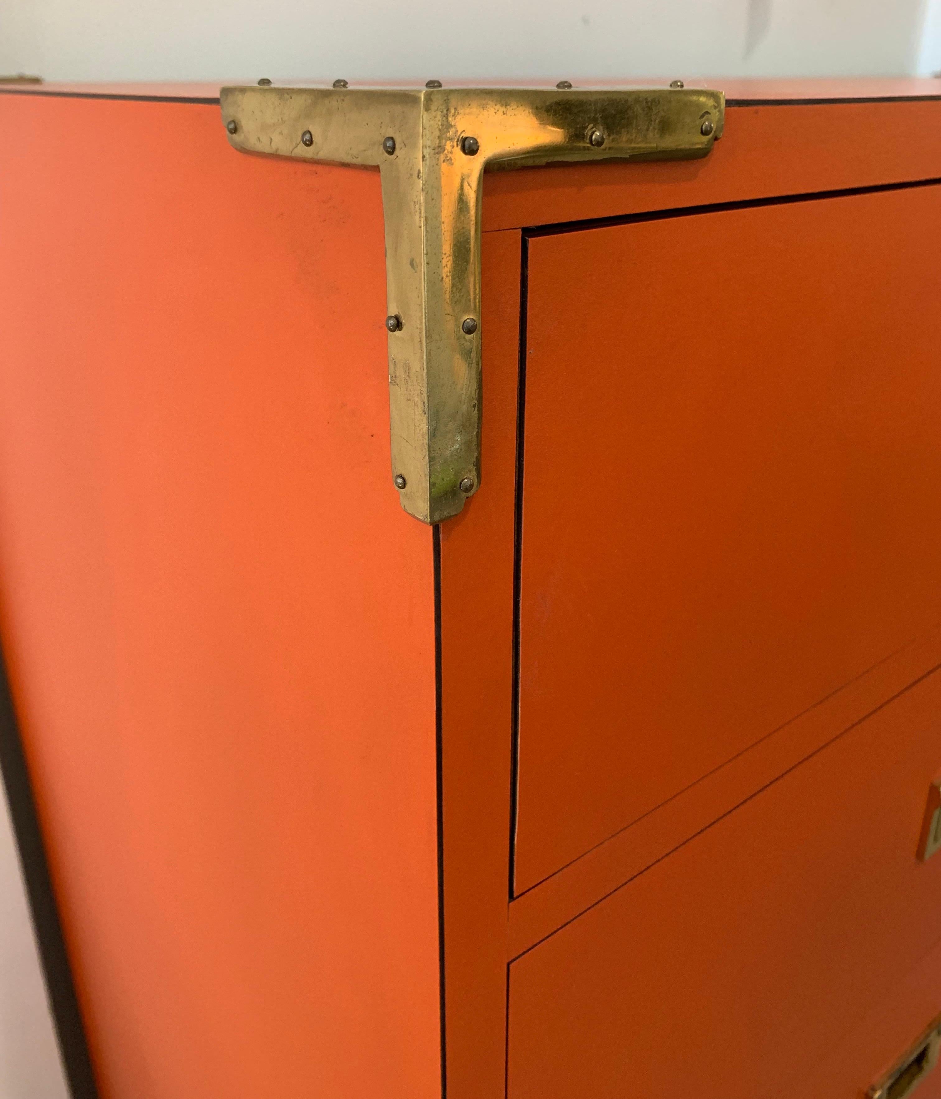 Not easy to find a dresser/highboy with twelve drawers. This one is done in the coveted Hermes orange color with brass hardware and that campaign style look that is always hard to find. Your search is now over. This is the very last piece of this
