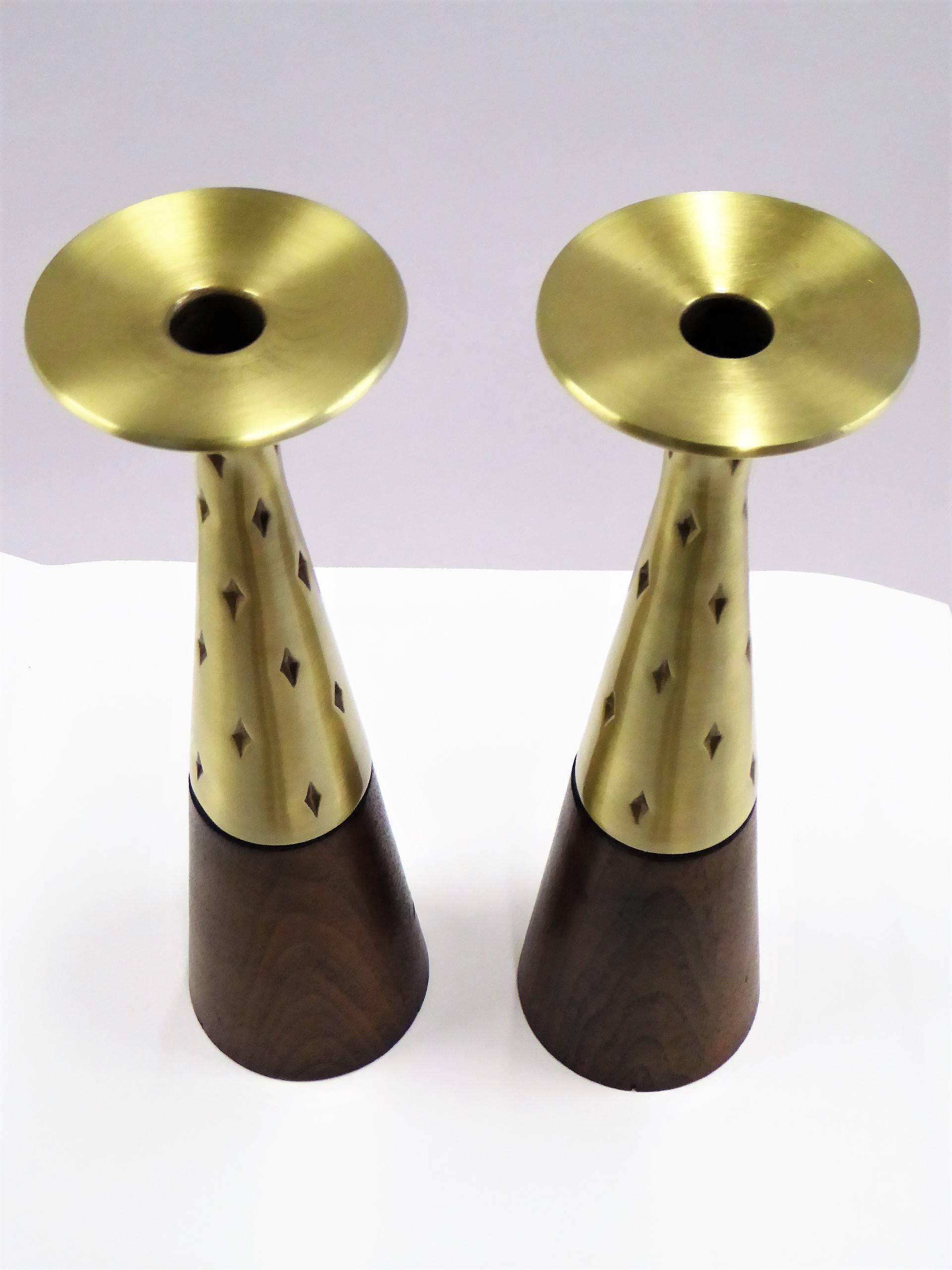 1950s midcentury Danish modern designed candlesticks by noted 20th century designer Tony Paul (1918-2010) for Westwood Chadwick in brass and walnut. With a modern tapered form, the brass with impressed diamond shapes. Brass re-polished, walnut