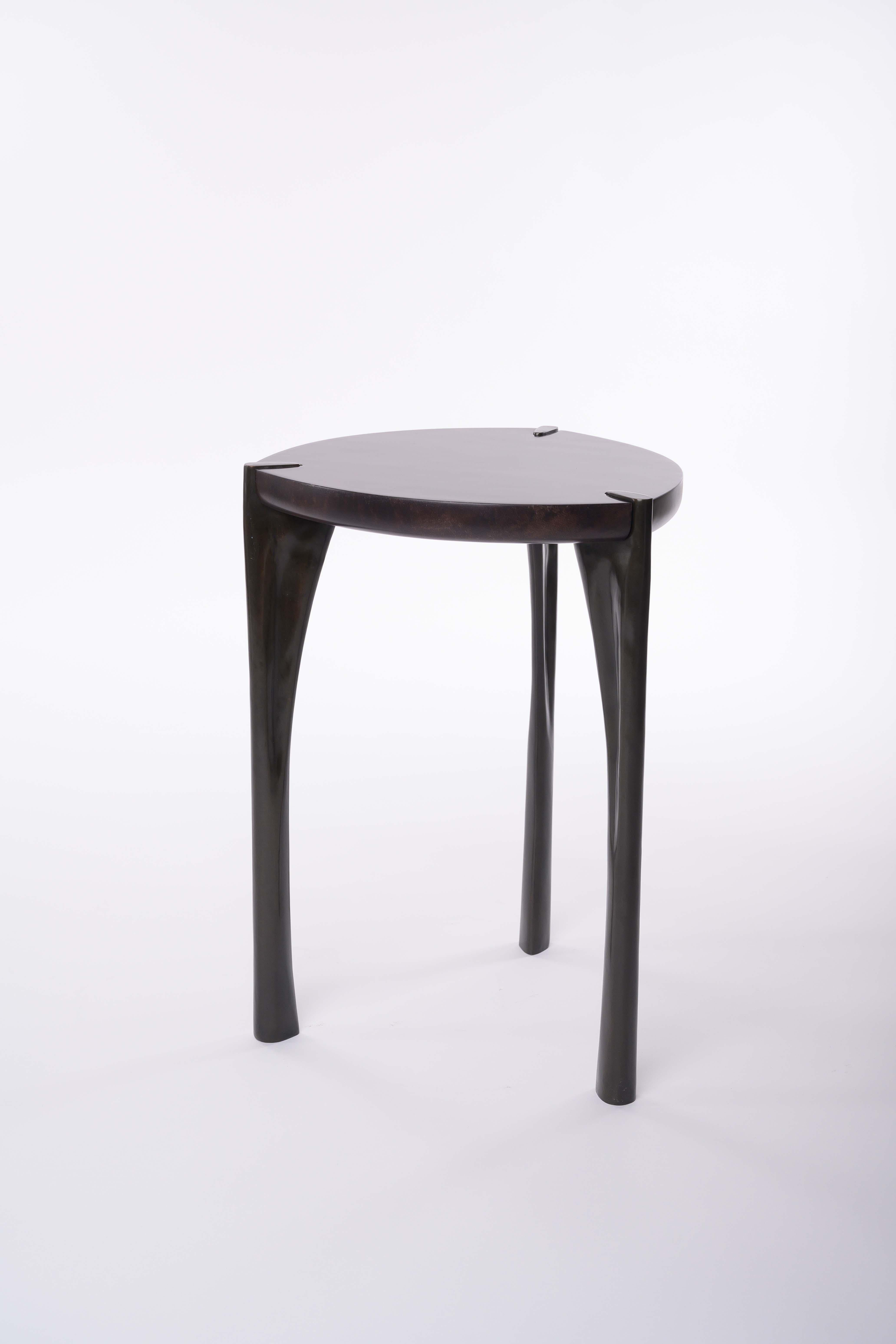 Made to order Tall Oscar Side Table with parchment top and cast bronze legs by Elan Atelier

The Oscar Side Tables, tall and low, are an elegant statement inspired by early to mid-century French furniture. The tapered bronze legs are in dark bronze