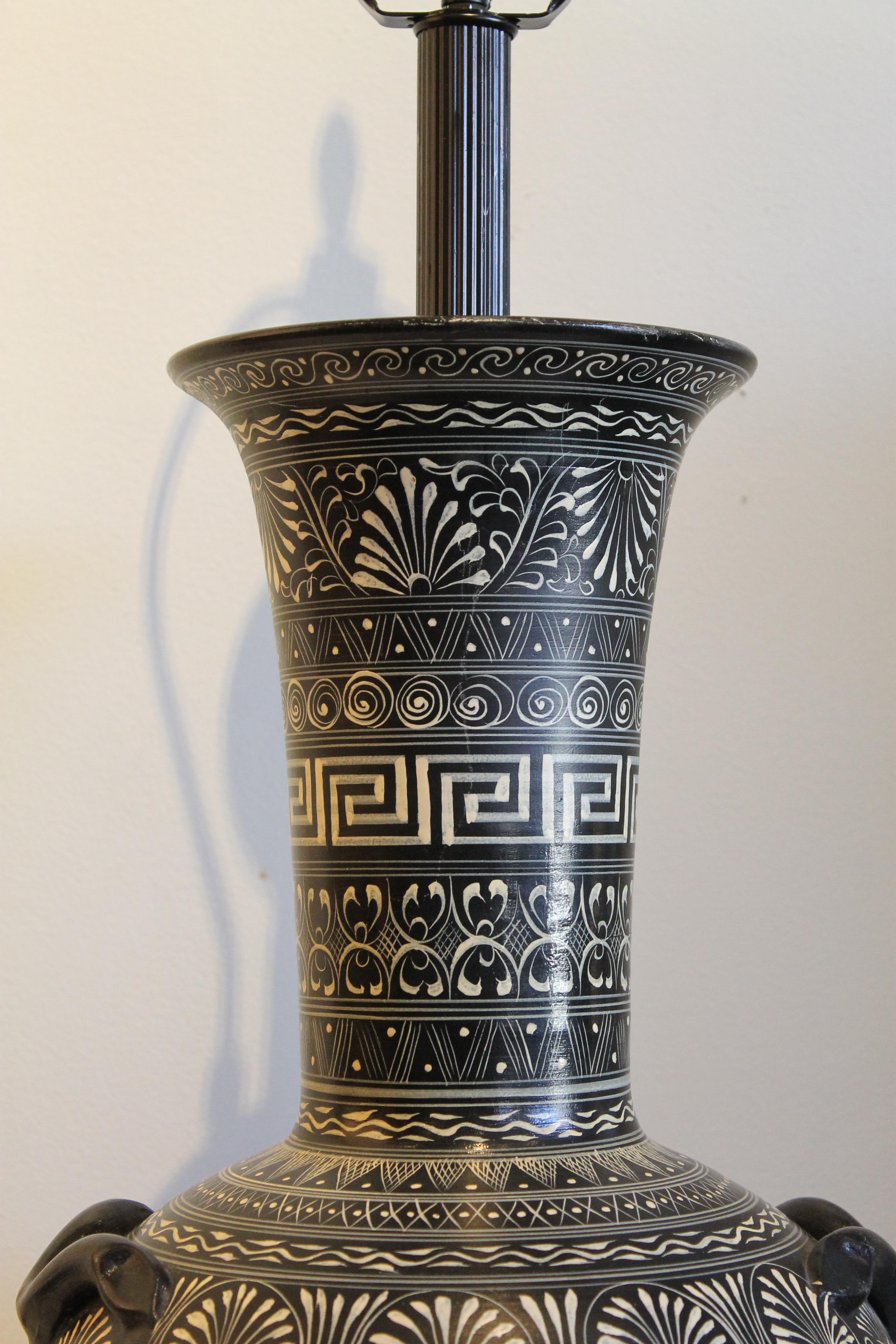 A monumental lamp made from a terra cotta urn or vase, first painted black, then overlaid with intricate patterns in the Greek style, all done by hand. A marble base was added. The lamp measures 27