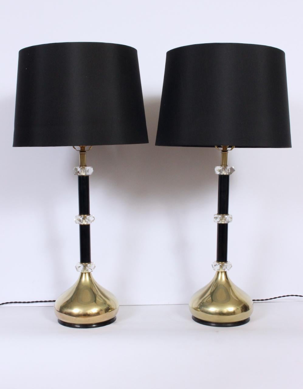 Substantial pair of Brass, Black Enamel and Faceted Lucite Crystal Table Lamps in the style of Frederick Cooper. Featuring Black enamel stems, three spaced faceted Lucite crystals per Lamp, rounded genie (golf club) style brass bases atop footed