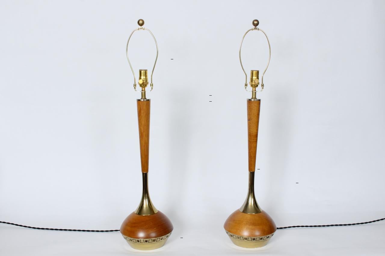 Tall Pair American Mid-Century Modern laurel lamp H-664 teak & brass table lamps. In the manner of Tany Paul. Featuring tapered cylindrical Teak stems to bulbous genie bottle form bodies, lacquered polished brass neck accents, plated metal bases