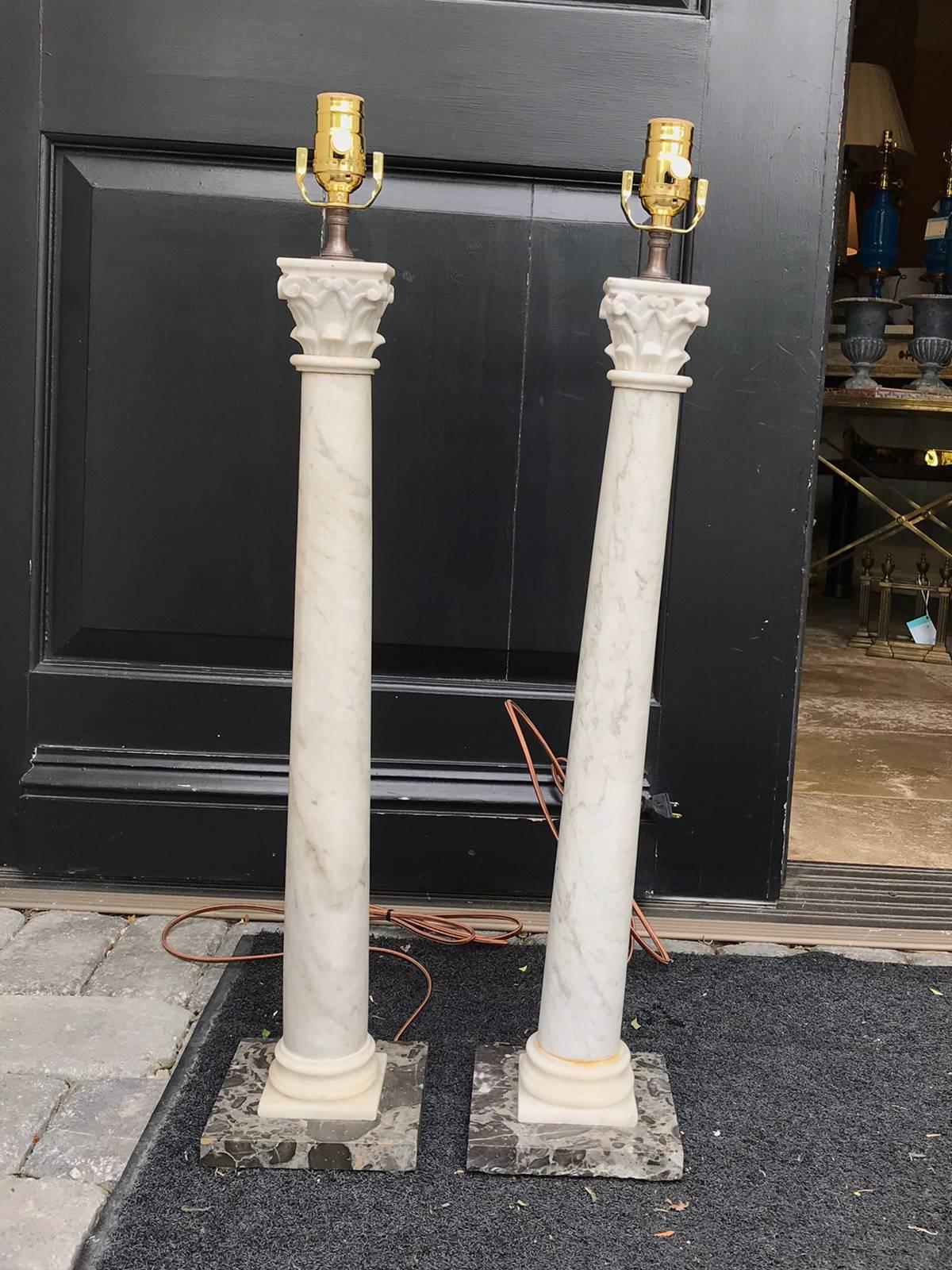 Tall pair of 19th century marble columns as lamps, black marble bases.