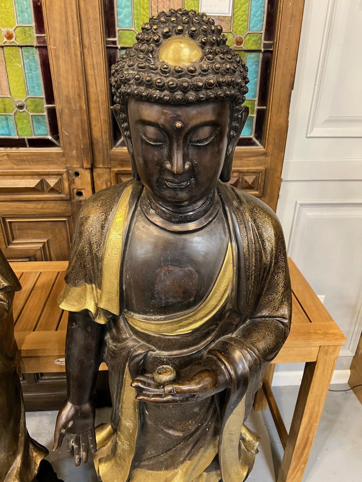 A large male and female pair dressed in flowing robes with gilt inlays. They stand upon integral bronze bases. This is a nice pair of large Tibetan Buddhism statues standing 5' tall. Overall in good condition some of the gilt inlays have faded as