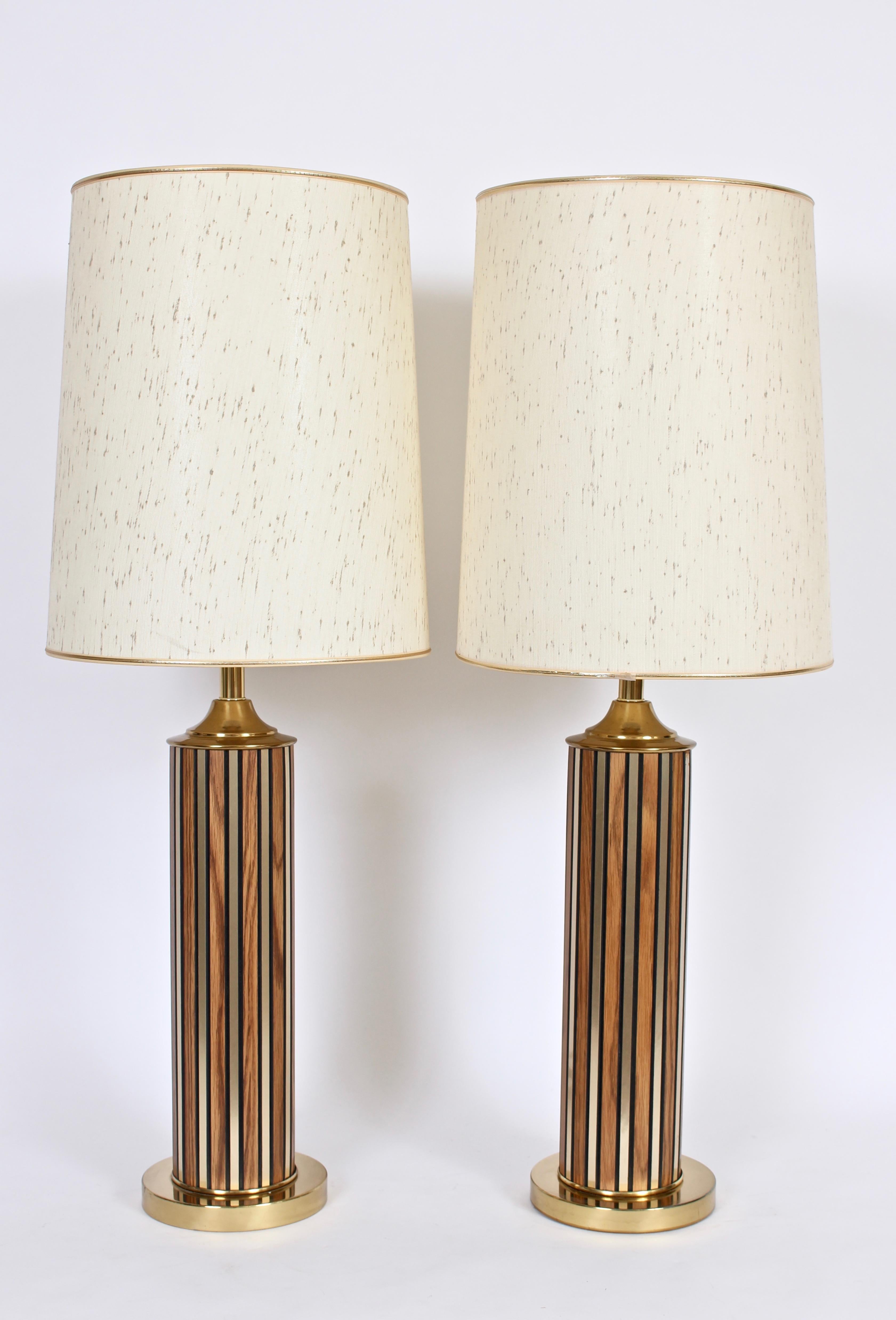 American modern cylinder table lamps with vertical striping in brass and walnut. Featuring a pillar form with fluctuating rectangular vertical strips in grained walnut and brass on a round brass base. Warm. Reflective. Statement lighting. Shade