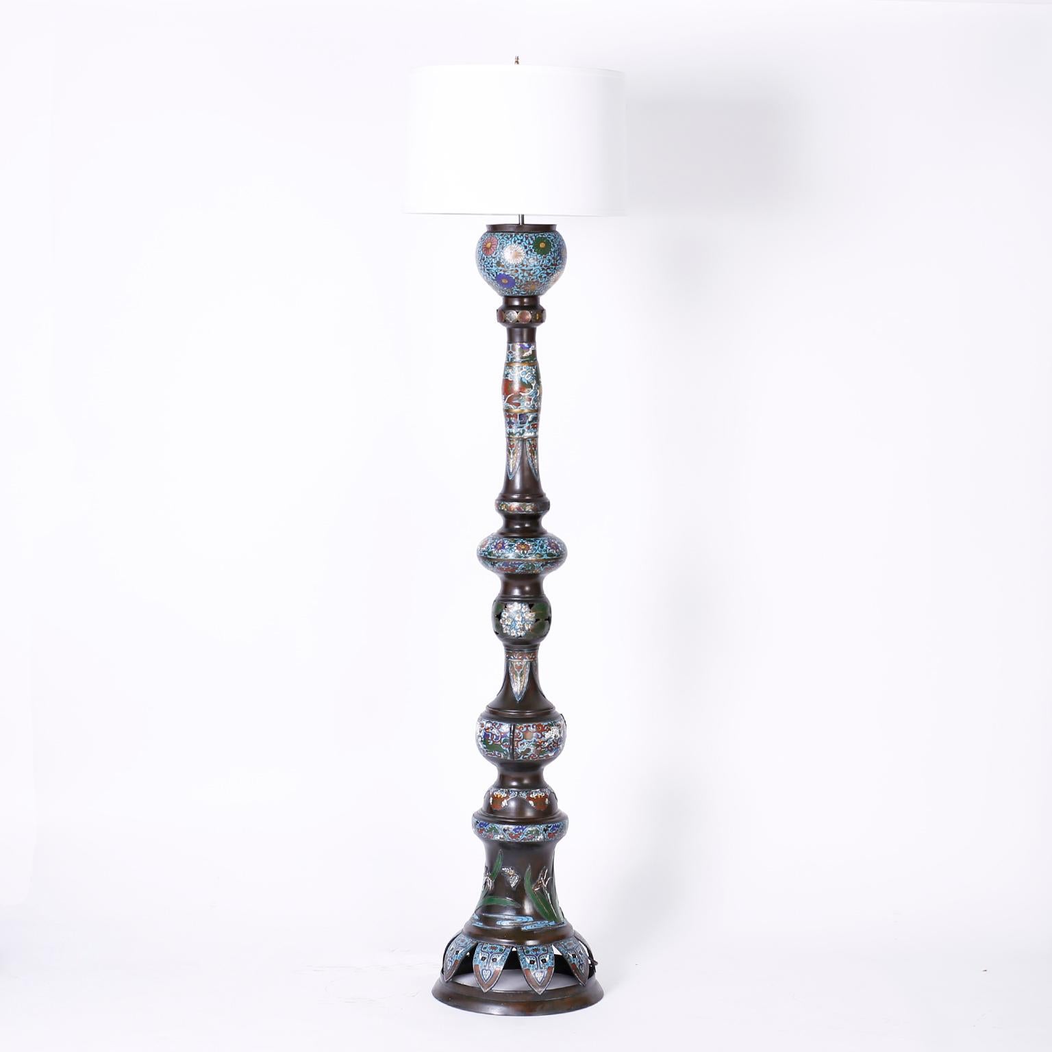 Rare pair of statuesque antique Cloisonné floor lamps crafted in bronze and decorated with enamel in floral and geometric designs.