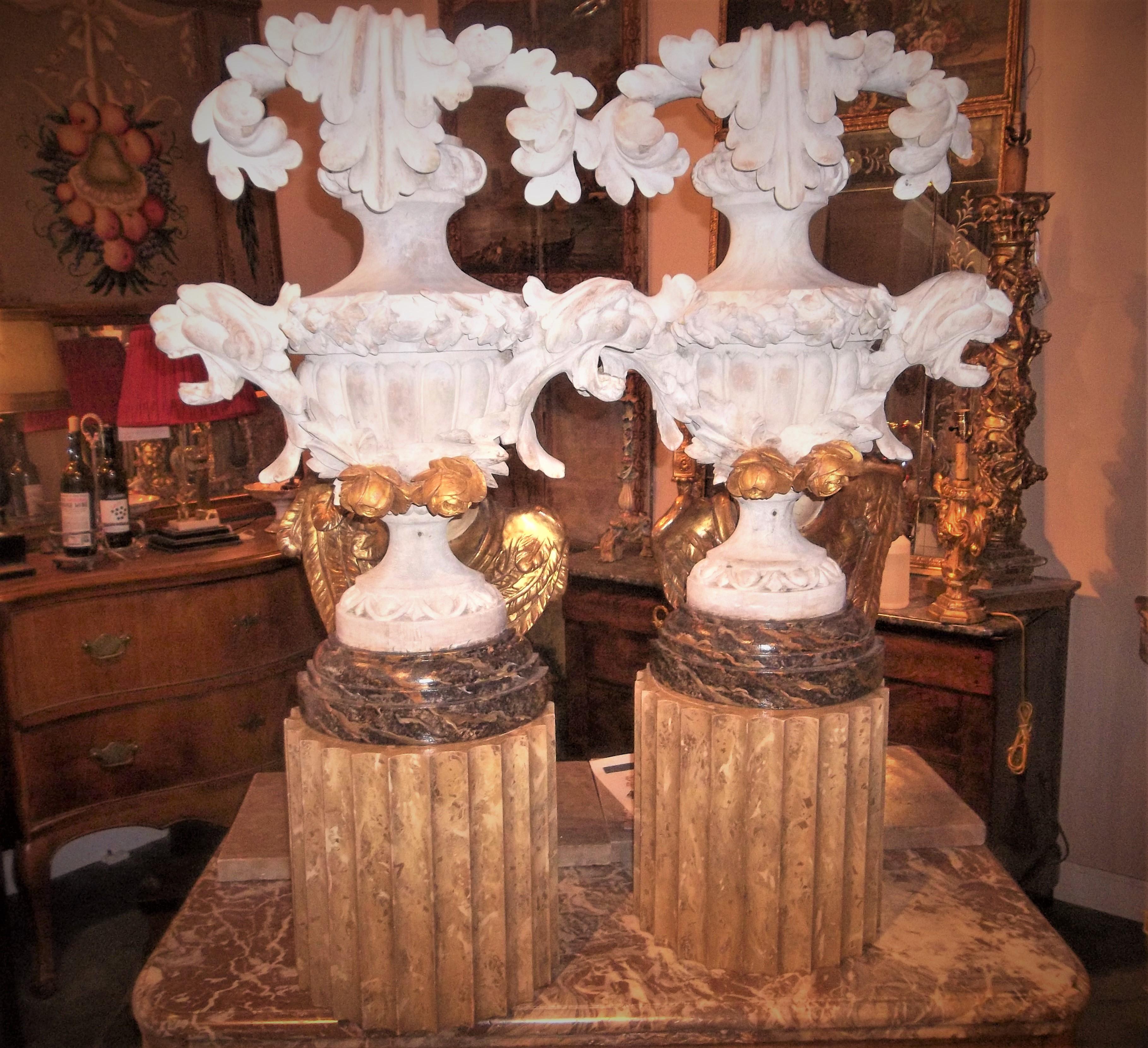 On black and gold faux marble bases. Possibly from an altar. Most likely gilded originally then stripped (traces of gesso and gilt) and white washed. Overall good condition but distressed finish from the original creation. 

Faux marble (black and