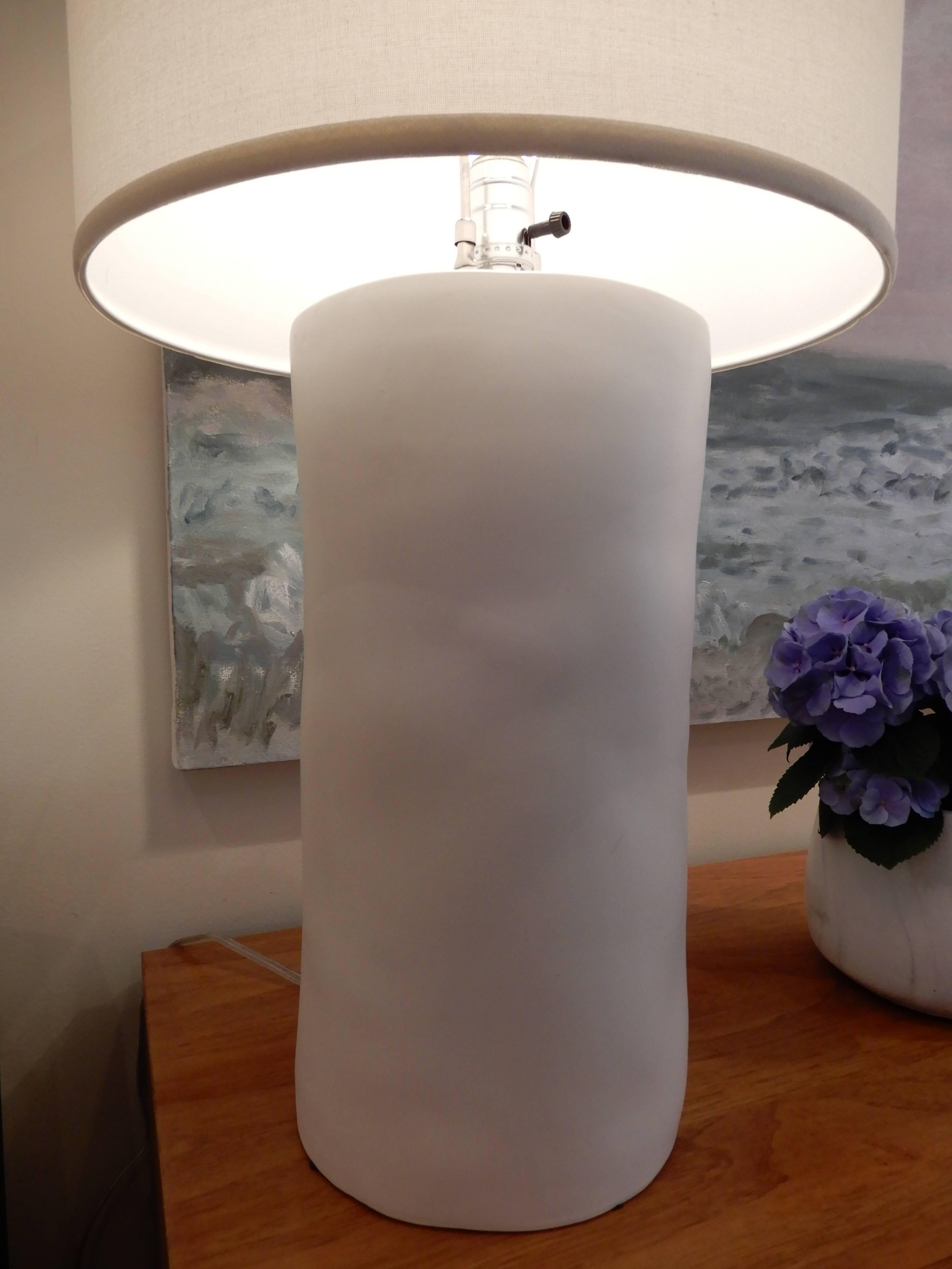 Make a statement with these tall handcrafted white ceramic lamps. Simple and natural lines with an organic texture to them, sold with the tall matching drum shade. Three way switch, two in stock the rest are made to order.
