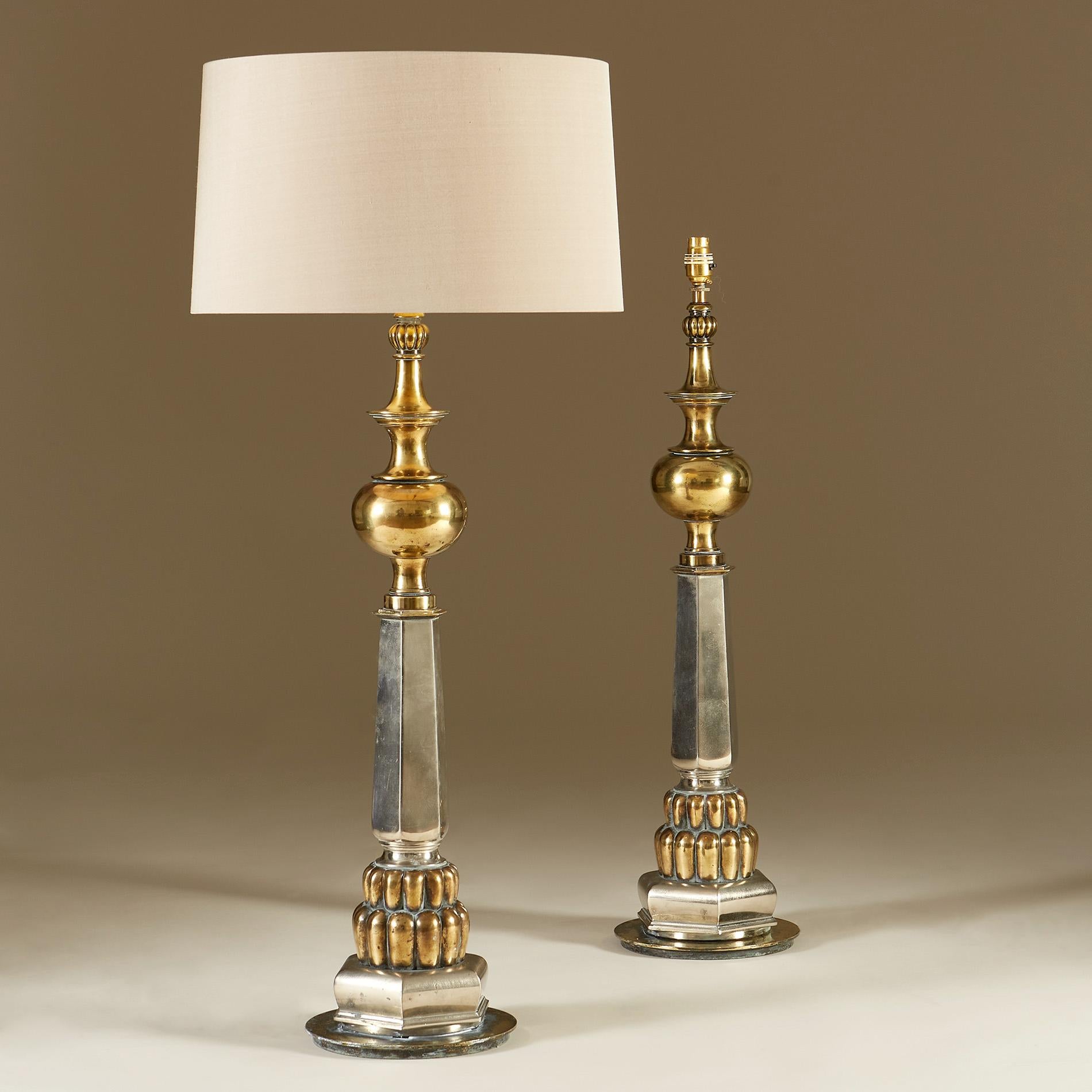 Imposing pair of architectural tall chrome and brass lamps. Bold shapes taper from circular base.