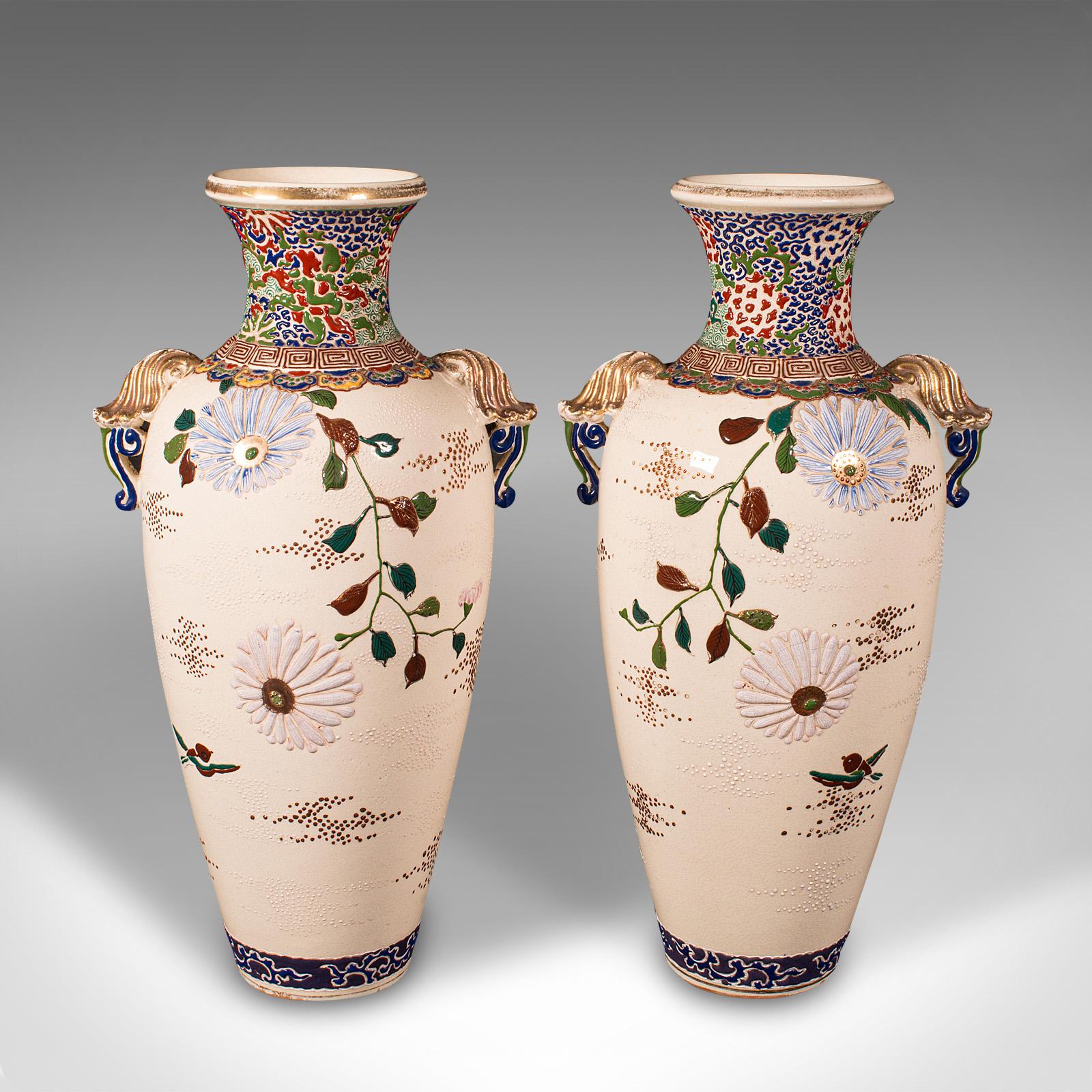 This is a tall pair of vintage Satsuma vases. A Japanese, ceramic flower urn in Oriental Art Deco taste, dating to the mid 20th century, circa 1940.

Classically decorative examples of Japanese ceramics
Displaying a desirable aged patina - both in